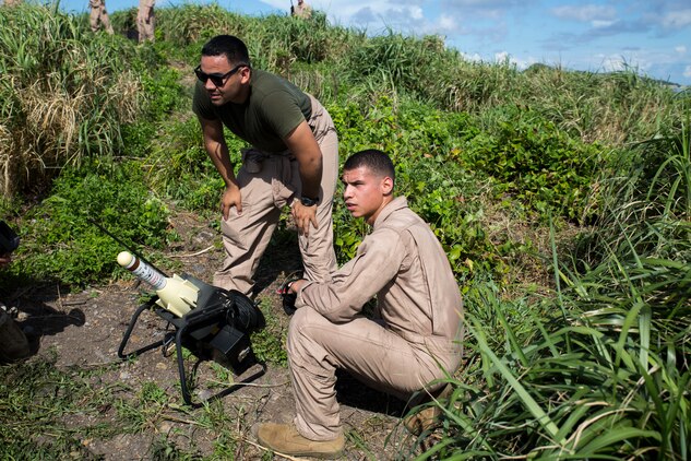 Lance Cpl. Marcos Bocanegra, right, and Lance Cpl. Cornelio Vasquez, ordnancemen with Marine Aerial Refueler Squadron 152 aim a GTR-18 missile, better known as a "Smokey SAM," at an incoming KC-130J Super Hercules during a threat reaction evolution on an island outside of Okinawa, Japan, Aug. 26, 2014. The threat reaction evolution is a chance for pilots to stay up to date on their qualifications while keeping an alert and aware mindset for any arising combat scenario.
