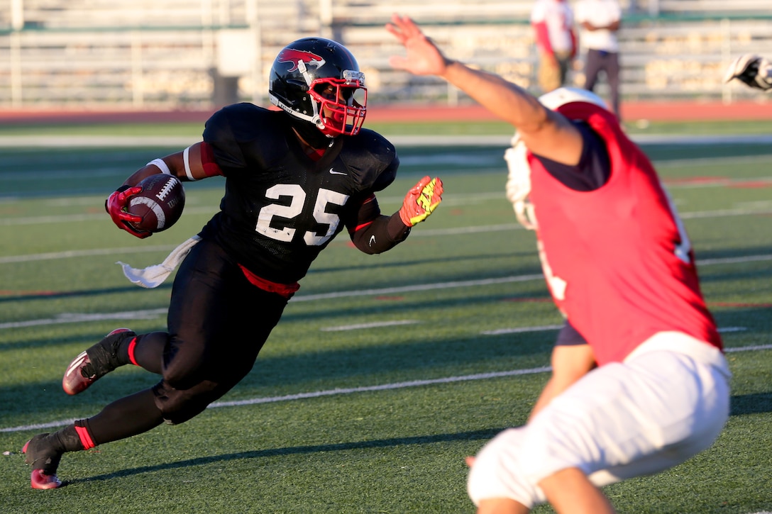 Kyle Byrdsong, Marine Corps Air Station Miramar Falcons’ running back, cuts to the inside during a game against the Headquarters Battalion, 1st Marine Division Standard Bearers at Paige Field House aboard Marine Corps Base Camp Pendleton, Calif., Aug. 26.  The Falcons defeated the Standard Bearers 19-8 and are set to face the 3rd Assault Amphibian Battalion Gators Sept. 9 at 5 p.m. at Paige Field House. 