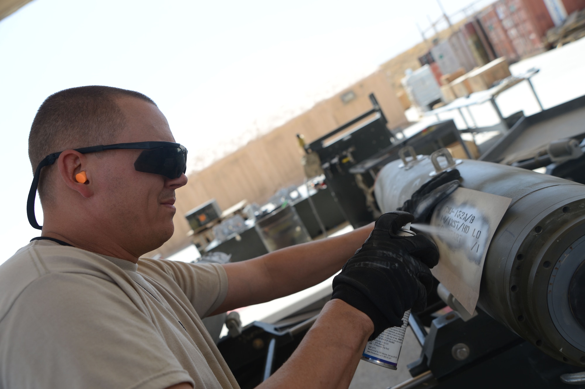 U.S. Air Force Master Sgt. John Pomilin, a native of Warrior, Ala. spray paints identification numbers on GB-38 bombs as part of the process of marking each bomb at Bagram Airfield, Afghanistan Aug. 14, 2014. This allows each bomb to be tracked and accounted for. The GBU is a principle part of the F-16C Fighting Falcon’s weapons system. Pomilin is an Air National Guardsman deployed from the 187th Fighter Wing in Montgomery, Ala. (U.S. Air Force photo by Master Sgt. Cohen A. Young/Released)
