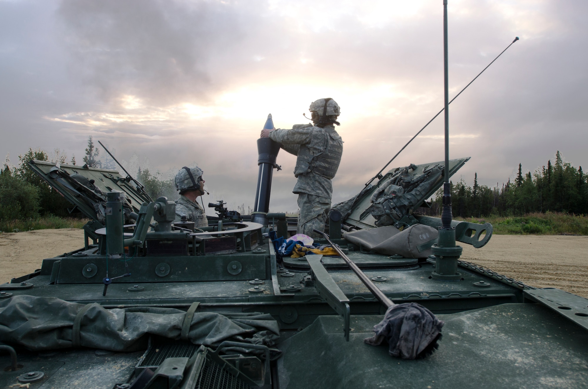 Army Private 1st Class Zachary Buckalew, left, and Army Private 1st Class Michael Hurley, both assigned to the 5th Squadron, 1st Cavalry Regiment, 1st Stryker Brigade Combat Team, U.S. Army Alaska, fire a 120mm mortar while their unit and U.S. Air Force Air National Guard Joint Terminal Attack Controllers train together at Yukon Training Area, Alaska, to hone joint interoperability and close air support capabilities in a high operations tempo simulated combat environment during the Red Flag-Alaska 14-3 exercise, Thursday, Aug. 21, 2014.  Joint Terminal Attack Controllers deploy with Army units, and bring to the fight an ability to quickly and accurately call close air support to engage enemy targets on the ground. Red Flag-Alaska, a series of Pacific Air Forces commander-directed field training exercises for U.S. forces, provides joint offensive counter-air, interdiction, close air support, and large force employment training in a simulated combat environment. (U.S. Air Force photo/Justin Connaher)