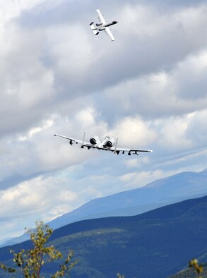 Two Fairchild Republic A-10 Thunderbolt IIs bank after a strafing run as Soldiers assigned to the 5th Squadron, 1st Cavalry Regiment, 1st Stryker Brigade Combat Team, U.S. Army Alaska, and U.S. Air Force Air National Guard Joint Terminal Attack Controllers training together at Yukon Training Area, Alaska, to hone joint interoperability and close air support capabilities in a high operations tempo simulated combat environment during the Red Flag-Alaska 14-3 exercise, Wednesday, Aug. 20, 2014.  Joint Terminal Attack Controllers deploy with Army units, and bring to the fight an ability to quickly and accurately call close air support to engage enemy targets on the ground. Red Flag-Alaska, a series of Pacific Air Forces commander-directed field training exercises for U.S. forces, provides joint offensive counter-air, interdiction, close air support, and large force employment training in a simulated combat environment. (U.S. Air Force photo/2LT Michael Harrington)