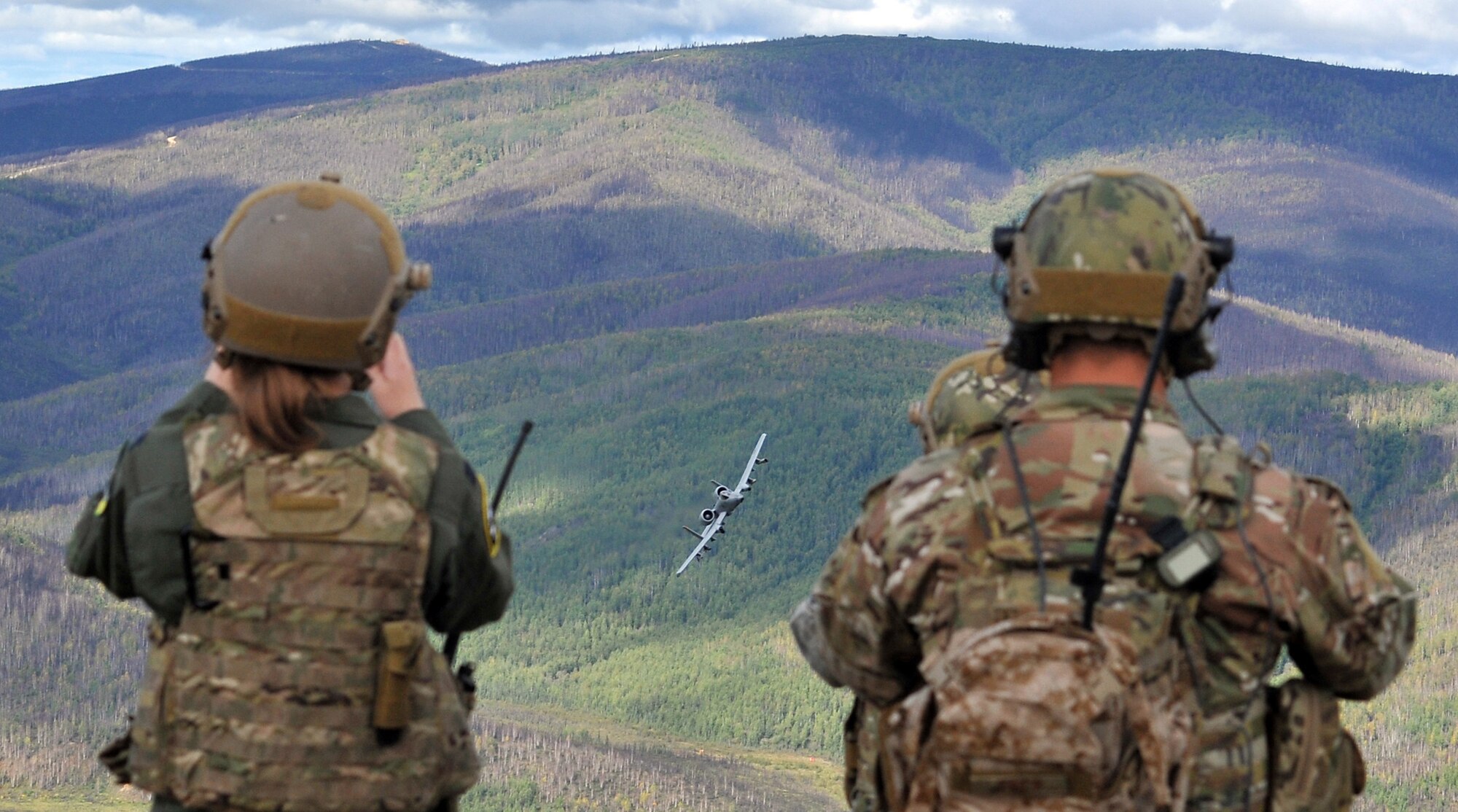 A Fairchild Republic A-10 Thunderbolt II banks toward U.S. Air Force Air National Guard Joint Terminal Attack Controllers and Soldiers assigned to the 5th Squadron, 1st Cavalry Regiment, 1st Stryker Brigade Combat Team, U.S. Army Alaska, training together at Yukon Training Area, Alaska, to hone joint interoperability and close air support capabilities in a high operations tempo simulated combat environment during the Red Flag-Alaska 14-3 exercise, Wednesday, Aug. 20, 2014.  Joint Terminal Attack Controllers deploy with Army units, and bring to the fight an ability to quickly and accurately call close air support to engage enemy targets on the ground. Red Flag-Alaska, a series of Pacific Air Forces commander-directed field training exercises for U.S. forces, provides joint offensive counter-air, interdiction, close air support, and large force employment training in a simulated combat environment. (U.S. Air Force photo/2LT Michael Harrington)