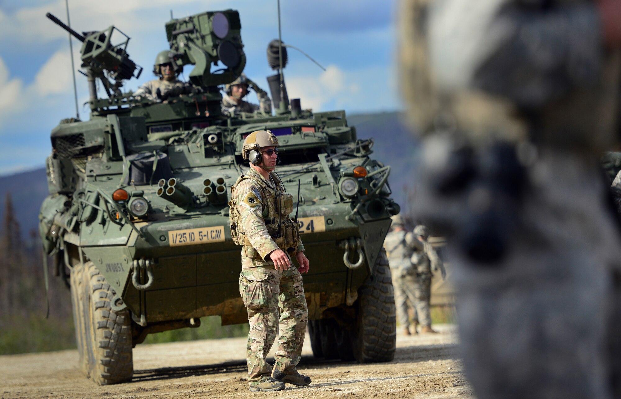 U.S. Air Force Lt. Col. J.B. Waltermire, squadron commander of the 140th Air Support Operations Squadron, walks in front of a M127 Stryker Reconnaissance Vehicle before Soldiers assigned to the 5th Squadron, 1st Cavalry Regiment, 1st Stryker Brigade Combat Team, U.S. Army Alaska, and U.S. Air Force Air National Guard Joint Terminal Attack Controllers train together at Yukon Training Area, Alaska, to hone joint interoperability and close air support capabilities in a high operations tempo simulated combat environment during the Red Flag-Alaska 14-3 exercise, Wednesday, Aug. 20, 2014.  Joint Terminal Attack Controllers deploy with Army units, and bring to the fight an ability to quickly and accurately call close air support to engage enemy targets on the ground. Red Flag-Alaska, a series of Pacific Air Forces commander-directed field training exercises for U.S. forces, provides joint offensive counter-air, interdiction, close air support, and large force employment training in a simulated combat environment. (U.S. Air Force photo/Justin Connaher)