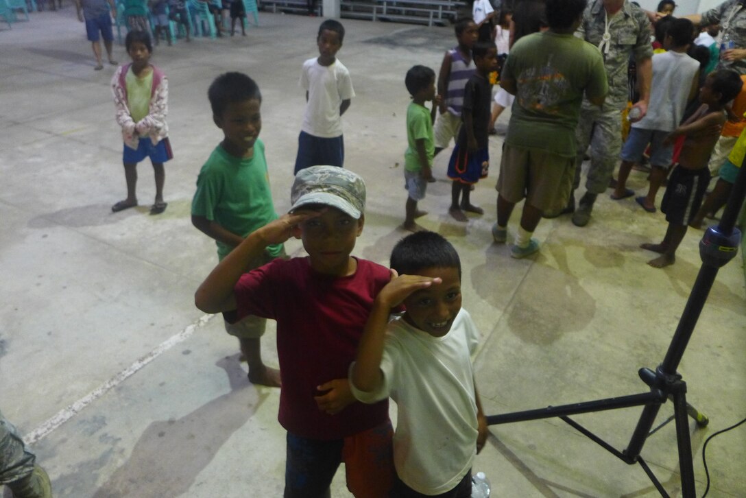 EBEYE,The Marshall Islands--  "Small Kine" performed on Ebeye, Aug. 16, 2014. Hundreds of people gathered in the Community Center to hear "Small Kine". It was a fun night, filled with dancing, singing, and games! The children of Ebeye loved to render a salute to the members of the band!
(A.F. Photo by TSgt Michael Smith/released)