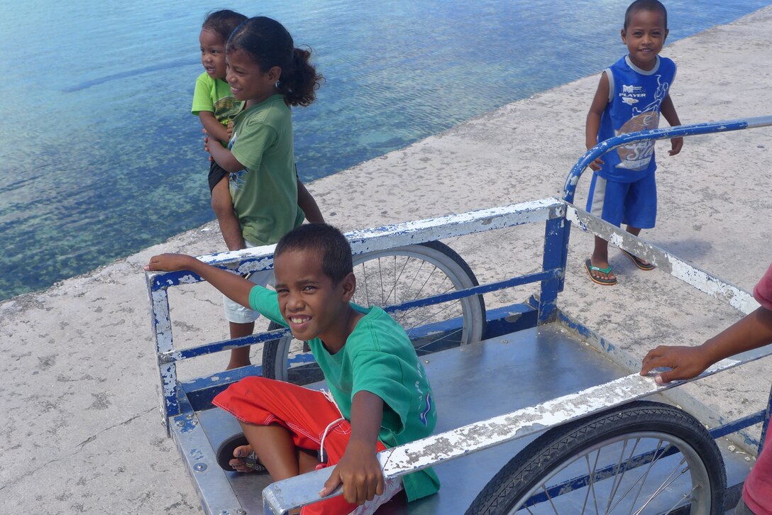 ENNUBIRR ISLAND,The Marshall Islands-- Some of the children on the island offered to help us with our load out after the show, Aug. 15, 2014.  "Small Kine" was the first live band to ever play on this small island, since there isn't any power or running water. "Small Kine" came prepared with a generator and a very talented audio engineer, TSgt Michael Smith! 
(A.F. Photo by TSgt Michael Smith/released)