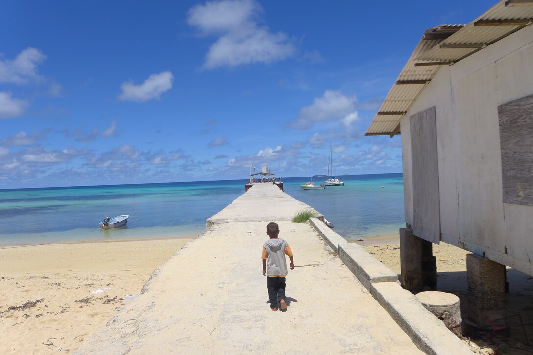ENNUBIRR ISLAND,The Marshall Islands-- A small Marshallese boy was showing us the way back to the pier, Aug. 15, 2014. You can't tell by this picture, but hundreds of children followed us to the pier, sending us off in style!  "Small Kine" was the first live band to ever play on this small island, since there isn't any power or running water. "Small Kine" came prepared with a generator and a very talented audio engineer, TSgt Michael Smith! 
(A.F. Photo by TSgt Michael Smith/released)