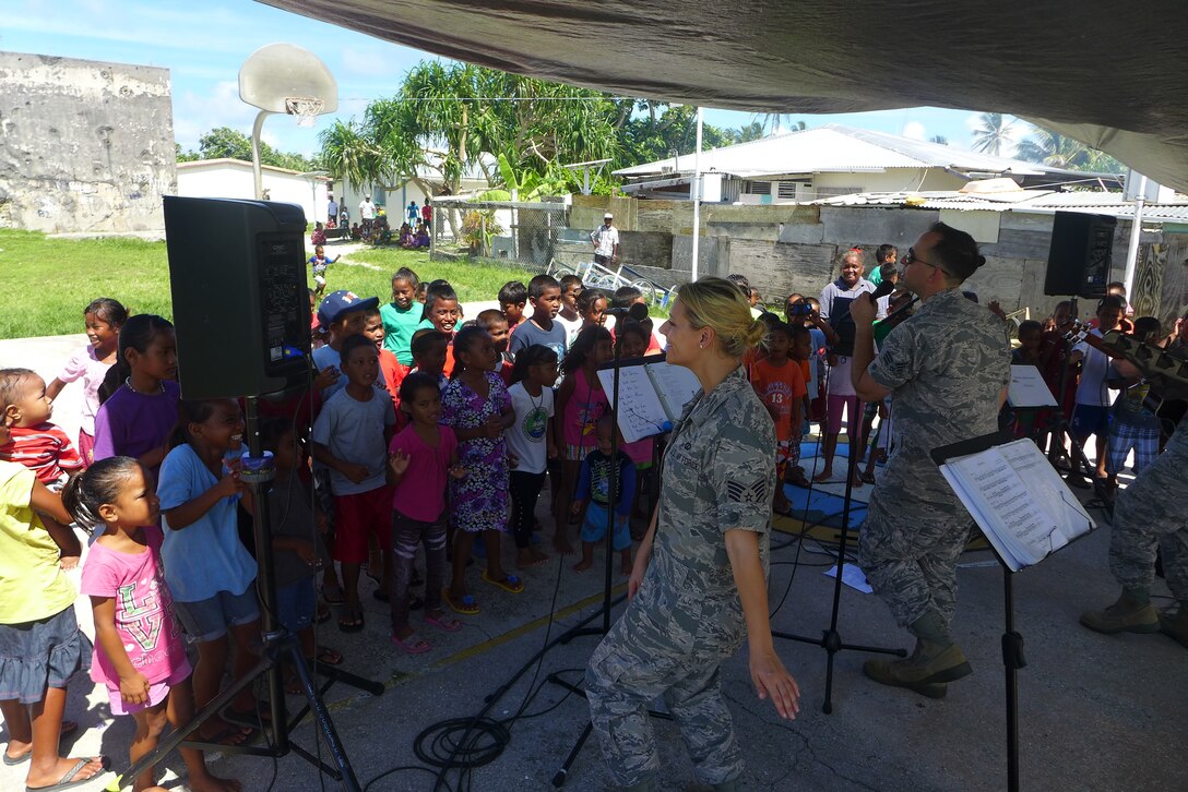 ENNUBIRR ISLAND,The Marshall Islands-- "Small Kine" is pictured here performing people of Ennubirr Island, Aug. 15, 2014. "Small Kine" was the first live band to ever play on this small island, since there isn't any power or running water. "Small Kine" came prepared with a generator and a very talented audio engineer, TSgt Michael Smith! 
(A.F. Photo by TSgt Michael Smith/released)