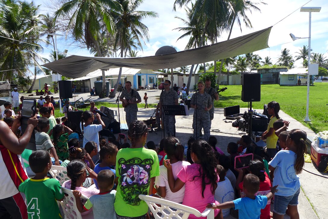 ENNUBIRR ISLAND,The Marshall Islands-- "Small Kine" is pictured here performing people of Ennubirr Island, Aug. 15, 2014. "Small Kine" was the first live band to ever play on this small island, since there isn't any power or running water. "Small Kine" came prepared with a generator and a very talented audio engineer, TSgt Michael Smith! 
(A.F. Photo by TSgt Michael Smith/released)