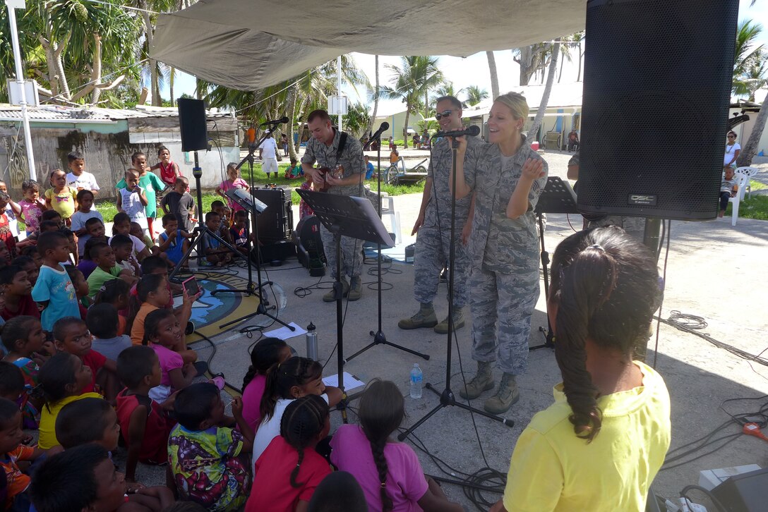 ENNUBIRR ISLAND,The Marshall Islands-- "Small Kine" is pictured here performing people of Ennubirr Island, Aug. 15, 2014. "Small Kine" was the first live band to ever play on this small island, since there isn't any power or running water. "Small Kine" came prepared with a generator and a very talented audio engineer, TSgt Michael Smith! 
(A.F. Photo by TSgt Michael Smith/released)