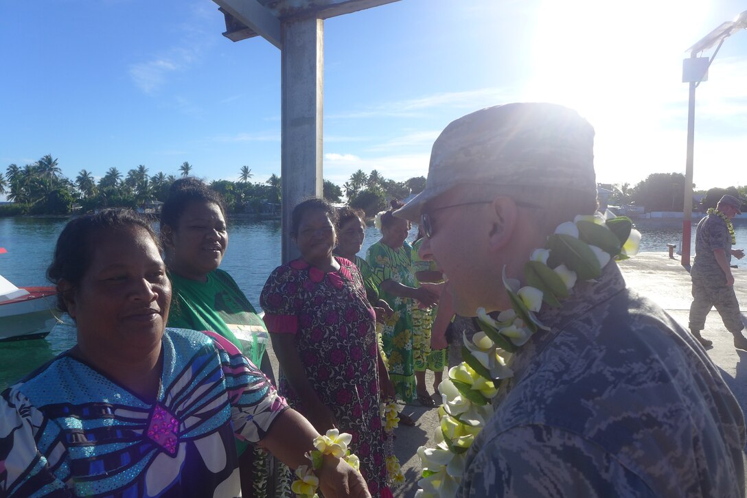 ENNUBIRR ISLAND,The Marshall Islands-- SrA Devin Rivas Martin receives a warm welcome from the people of Ennubirr Island, Aug. 15, 2014. "Small Kine" was the first live band to ever play on this small island, since there isn't any power or running water. "Small Kine" came prepared with a generator and a very talented audio engineer, TSgt Michael Smith! 
(A.F. Photo by TSgt Michael Smith/released)