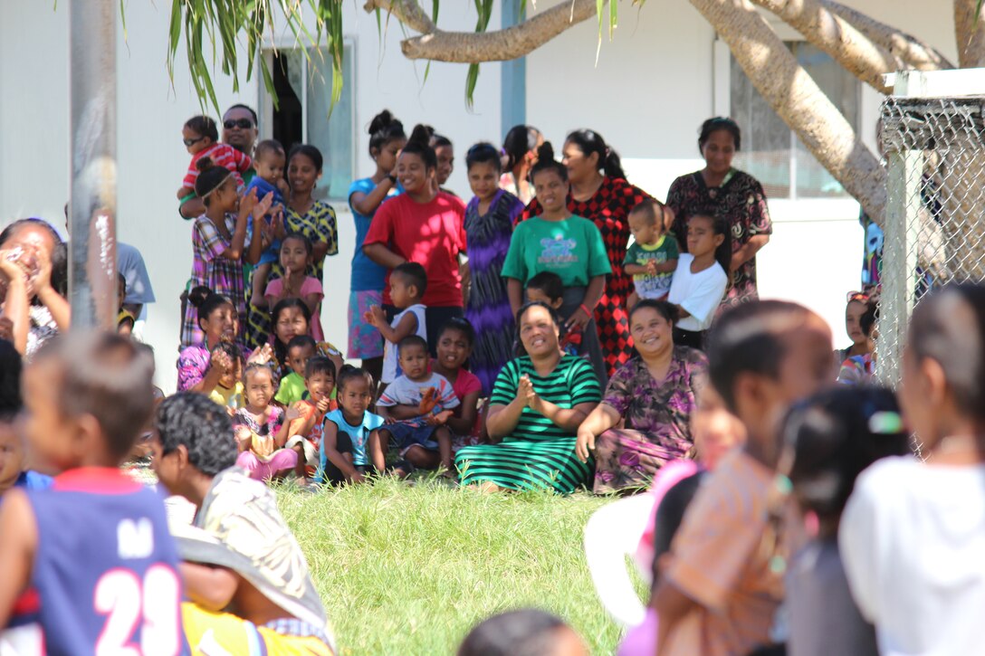 ENNUBIRR ISLAND,The Marshall Islands-- Marshallese from Ennubirr (aka Third Island), patiently awaits for "Small Kine" to start the show, Aug. 15, 2014.The crowd was excited for the performance, since it was the first time a live band has ever been there to play. There isn't any power or running water on Third Island, so it makes it difficult for bands to perform. Luckily, "Small Kine" came prepared with a generator and a very talented audio engineer, TSgt Michael Smith! 
(A.F. Photo by TSgt Michael Smith/released)