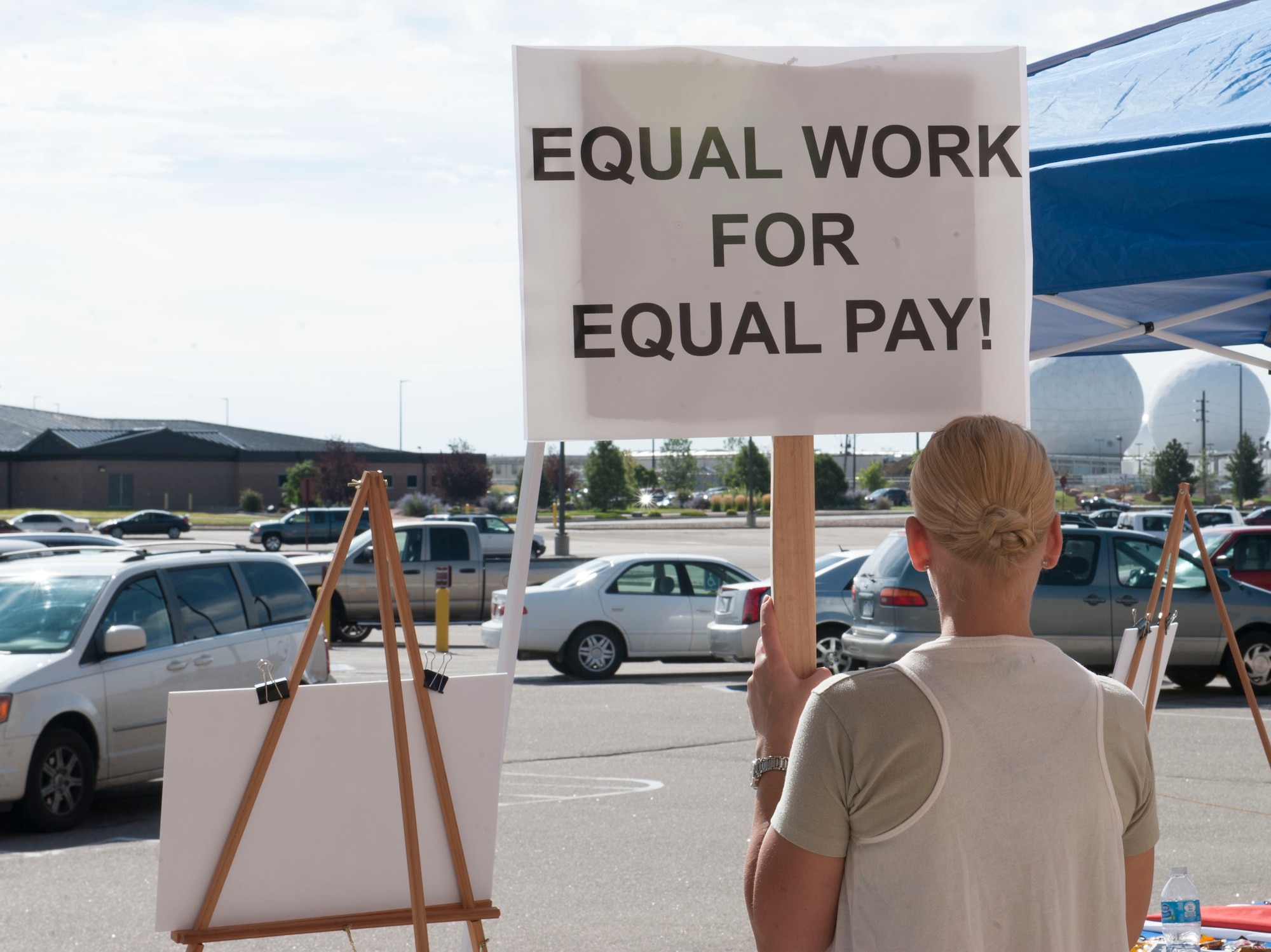 Tech. Sgt. Amy Szpak, Air Reserve Personnel Center retirement counselor, holds a sign during a peaceful protest in honor of Women’s Equality Day Aug. 26, 2014, on Buckley Air Force Base, Colo. Women’s Equality Day commemorates the ratification of the 19th Amendment, granting women the right to vote. Today, it is celebrated in honor of modern day women’s rights to be seen as equals to men. (U.S. Air Force photo by Airman 1st Class Samantha Saulsbury/Released)