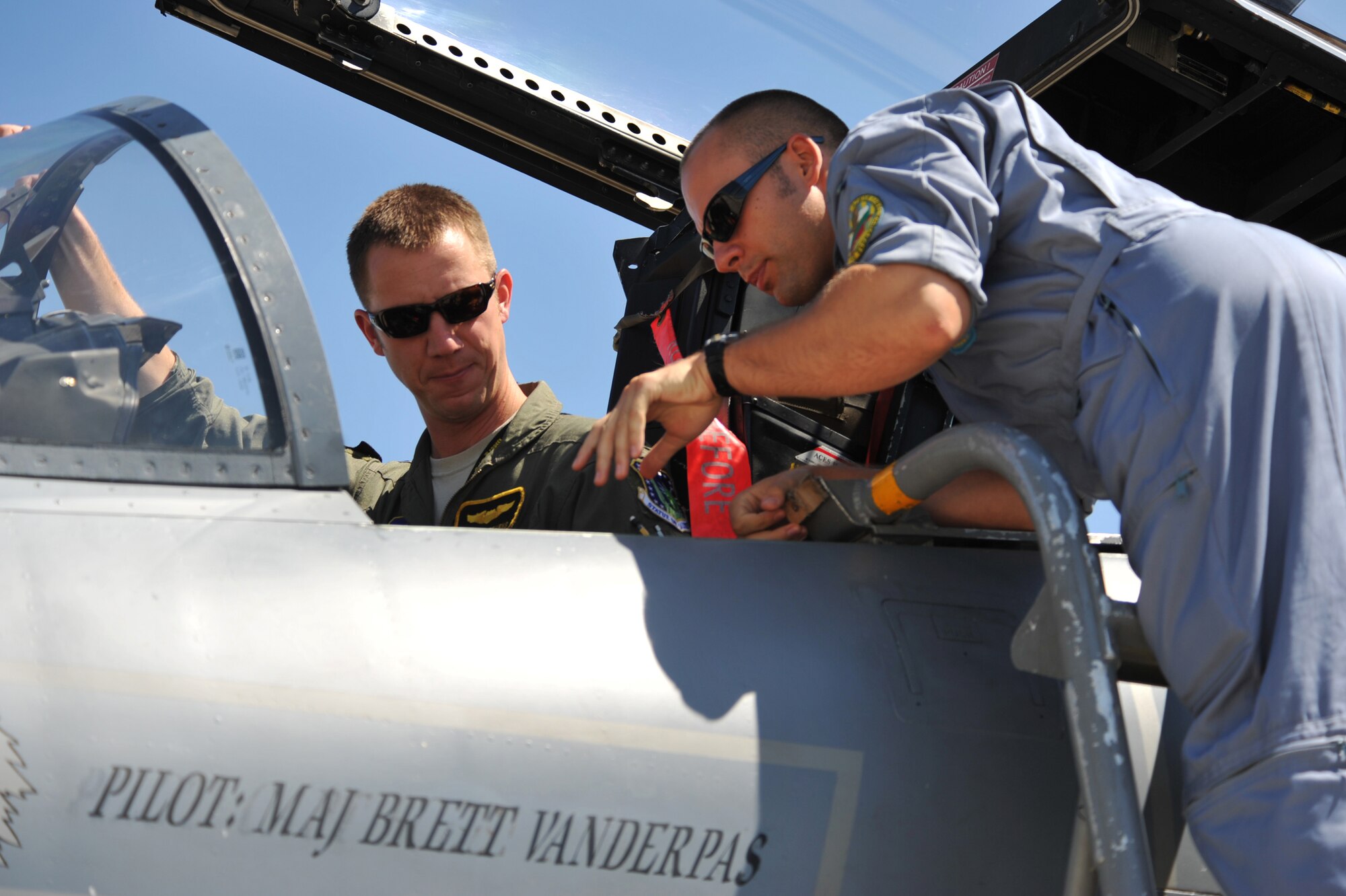 A pilot from the 493rd Fighter Squadron shows a Bulgarian pilot what the inside of an F-15C Eagle cockpit looks like at Graf Ignatievo Air Base near Plovdiv, Bulgaria Aug. 19, 2014. Pilots, maintainers and a mixture of other professions from Royal Air Force Lakenheath, England, will enhance interoperability with Bulgaria and maintain joint readiness. (U.S. Air Force photo/Senior Airman Hailey Haux)