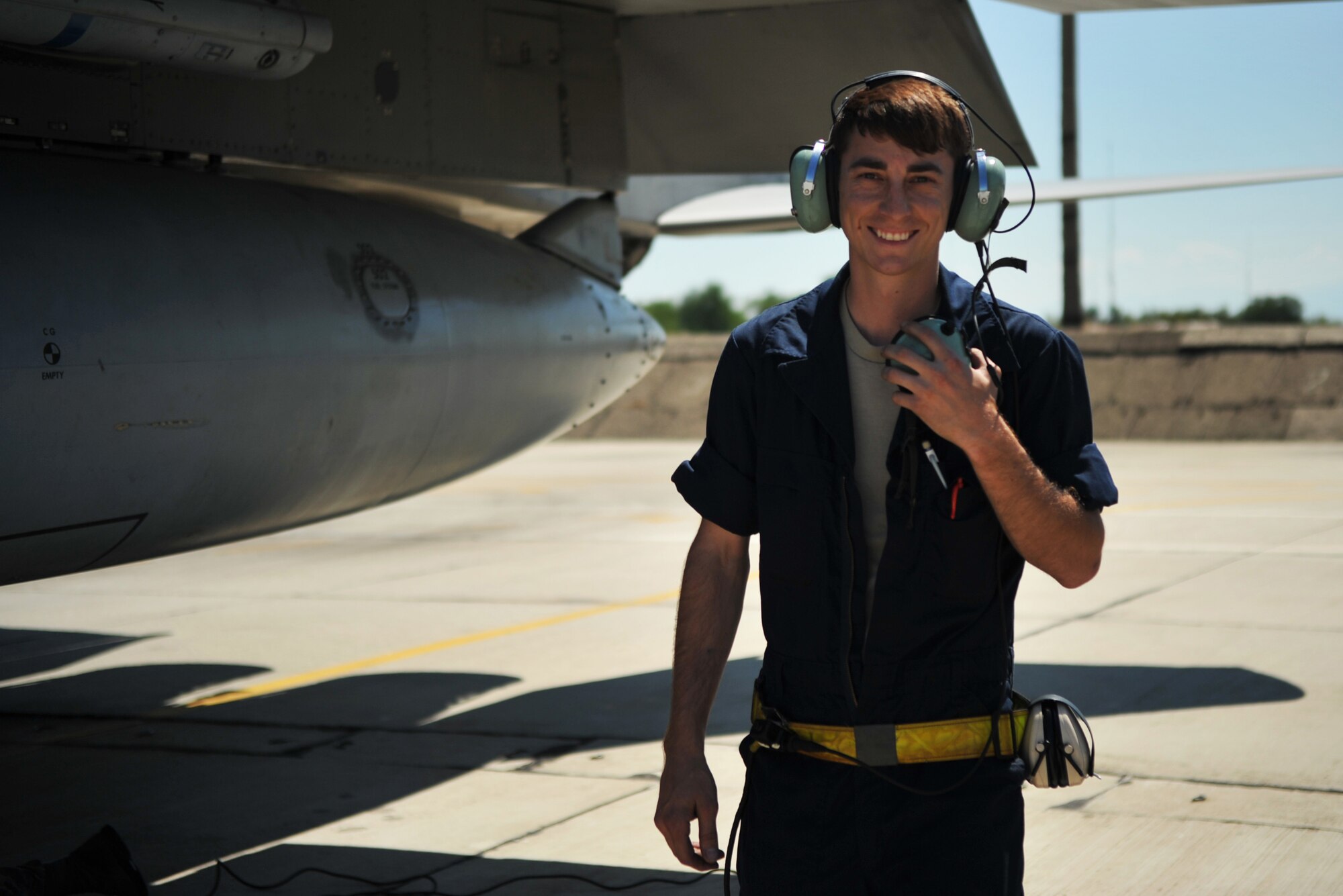 Senior Airman Skylar Richards, 493rd Aircraft Maintenance Unit crew chief, smiles after doing his pre-flight checks on the F-15C Eagle at Graf Ignatievo Air Base near Plovdiv, Bulgaria, Aug. 19, 2014. There are many duties a crew chief preforms, one of them being to ensure the pilot taxis in and out of their parking spot safely. (U.S. Air Force photo/Senior Airman Hailey Haux)