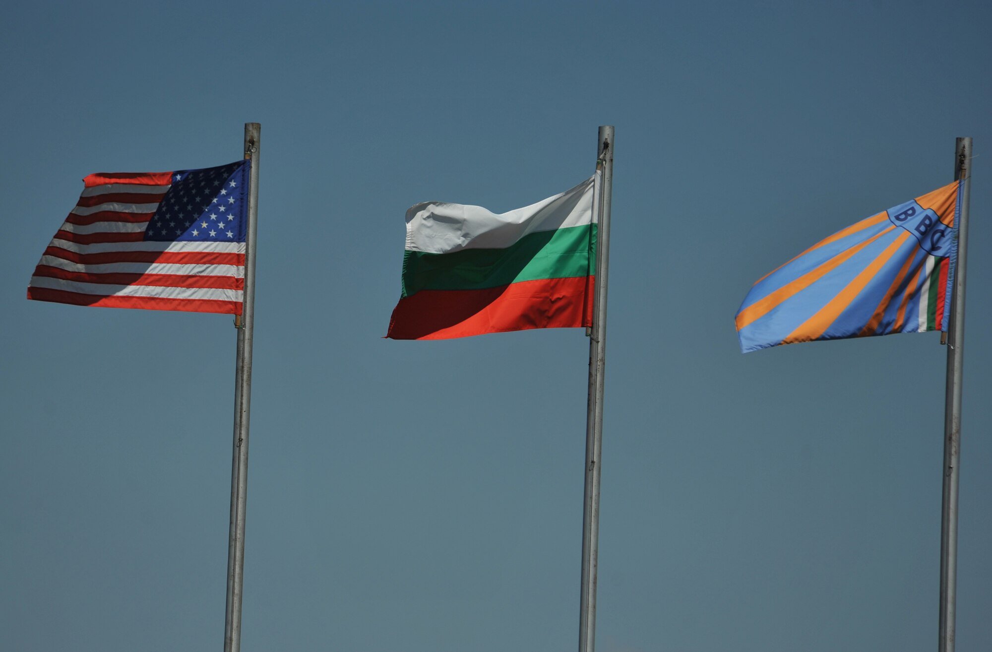 Flags flap in the wind at Graf Ignatievo Air Base near Plovdiv, Bulgaria Aug. 19, 2014. More than 180 Airmen from U.S. Air Forces in Europe and Air Forces Africa flew to Bulgaria to participate in a bilateral training event, Thracian Eagle 2014, Aug. 18 through Sep. 1. (U.S. Air Force photo/Senior Airman Hailey Haux)