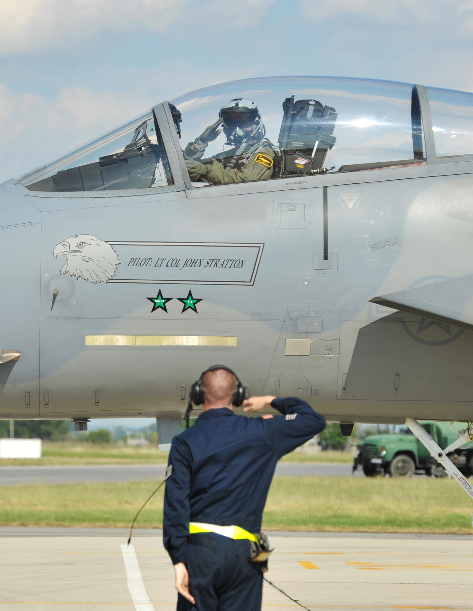A crew chief salutes his pilot after marshaling him off at Graf Ignatievo Air Base near Plovdiv, Bulgaria, Aug. 18, 2014. There are many duties a crew chief performs, one of them being to ensure the pilot taxis in and out of their parking spot safely. (U.S. Air Force photo/Senior Airman Hailey Haux)
