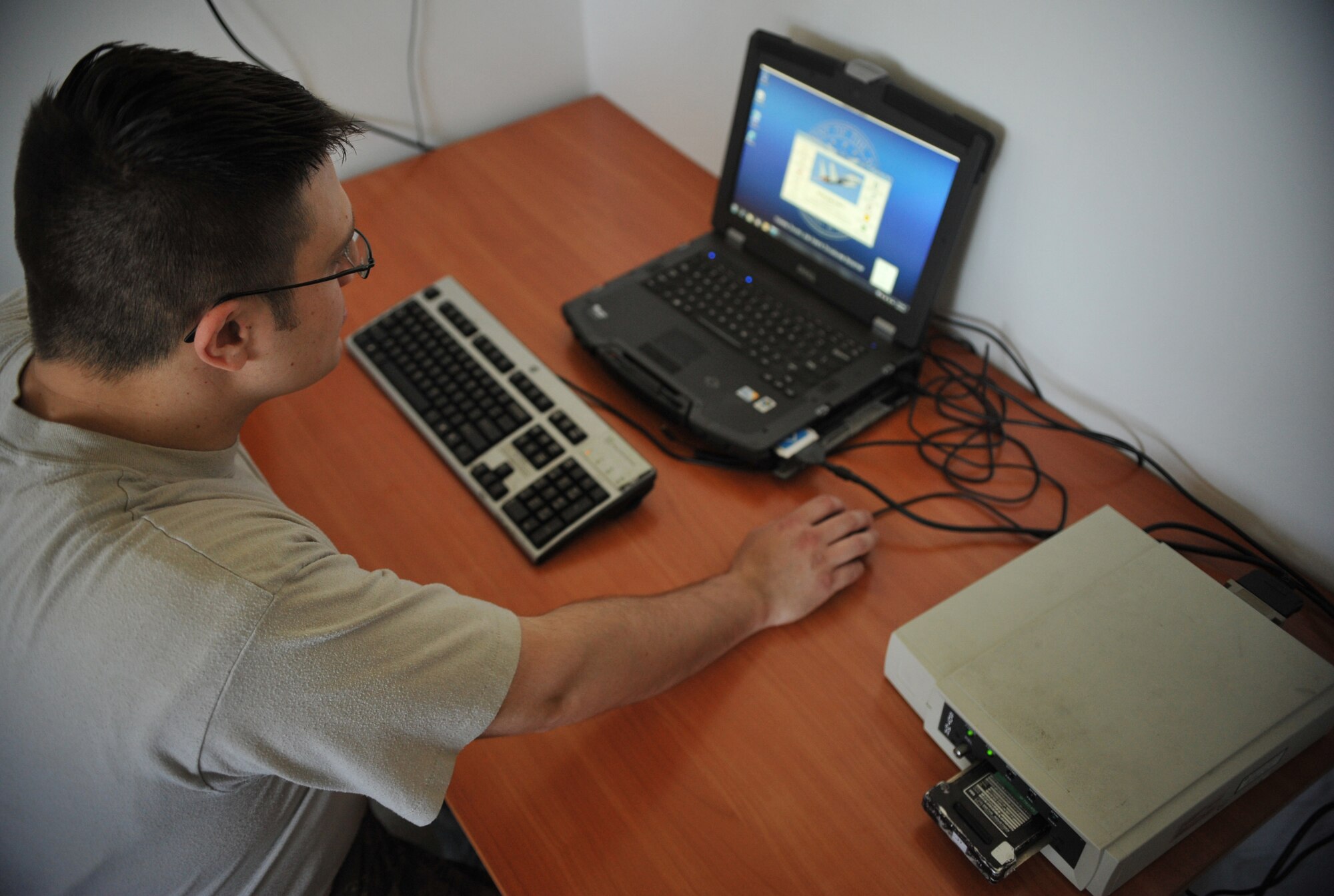 Tech. Sgt. Jonathan Easter, 493rd Aircraft Maintenance Unit maintenance debrief, sets up shop at Graf Ignatievo Air Base near Plovdiv, Bulgaria, Aug. 18, 2014. Easter is in charge of ensuring correct maintenance records are kept on the F-15C Eagle. (U.S. Air Force photo/Senior Airman Hailey Haux)