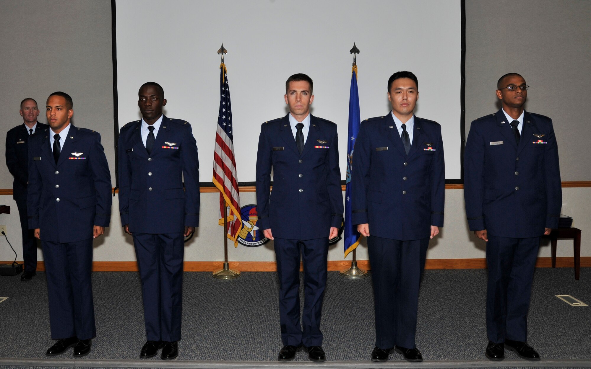 Five Team Tyndall graduates stand at attention during their Air Battle Manager Class 14016 graduation ceremony Aug 27. (U.S. Air Force photo by Airman 1st Class Sergio Gamboa)