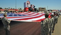 Team Beale and members of the California State Military Reserve hold a large American flag during the opening ceremonies of the IndyCar GoPro Grand Prix Aug. 24, 2014, at Sonoma Raceway in Sonoma Calif. Approximately 30 Beale Airmen and more than 100 military members performed during the opening ceremonies. (U.S. Air Force photo by Airman 1st Class Ramon A. Adelan/ Released)