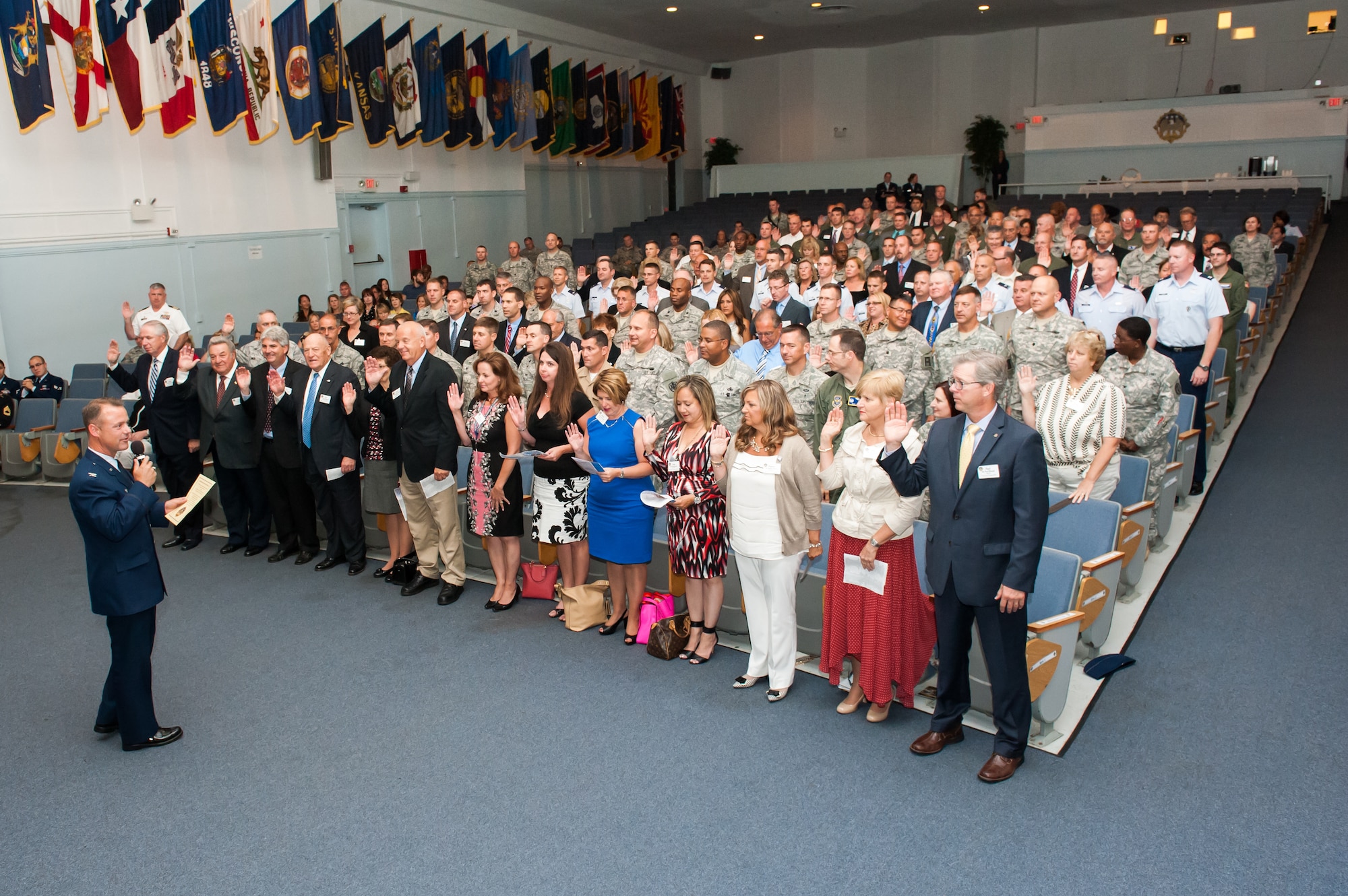 Col. James C. Hodges, 87th Air Base Wing and Joint Base McGuire-Dix-Lakehurst, N.J. commander, administers the Honorary Commanders Oath to new appointees Aug. 20, 2014, at the Timmerman Center on JB MDL. Each honorary commander will serve a one year term, play an active role in the community, and share their Air Force, Army, Navy and joint base experiences with those within their sphere of influence. They must also have a positive impact on public support for JB MDL. (U.S. Air Force photo by Russ Meseroll/Released)