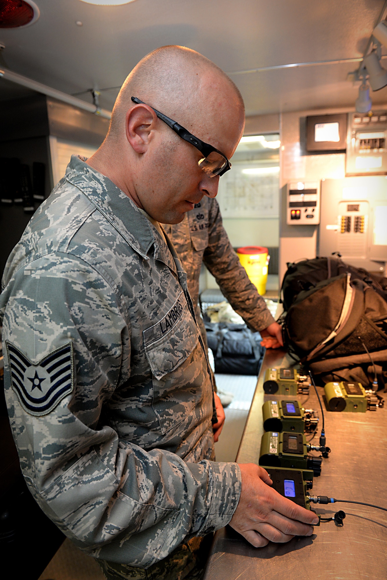 Tech. Sgt. Dustin Lambries syncs the radio transmitters in preparation for an explosion demonstration Aug. 22, 2014, at Scott Air Force Base, Ill. The demonstration marked the opening for the Explosive Ordnance Disposal Proficiency Range. Lambries is the 375th Civil Engineer Squadron EOD operations section chief. (U.S. Air Force photo/Senior Airman Jake Eckhardt)
