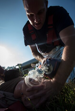 Zac Wojcik, 628th Civil Engineer Squadron firefighter, performs resuscitation exercises on a dummy during a Major Accident Response Exercise Aug. 20, 2014, at North Auxiliary Air Field. The MARE simulated a C-17 in-flight emergency resulting in a simulated crash at North Field. The 628th Air Base Wing, 437th Airlift Wing and Orangeburg County Emergency services participated in the functional MARE. (U.S. Air Force photo/ Senior Airman Dennis Sloan)