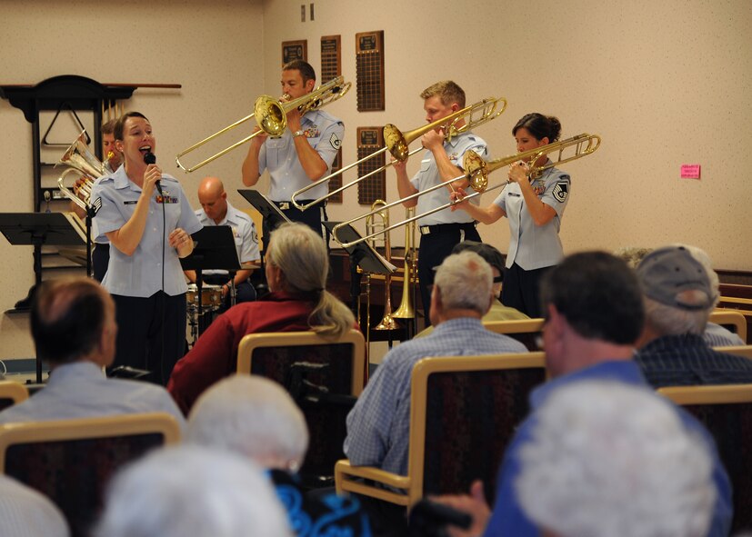 Staff Sgt. Melissa Evans, U.S. Air Force Band of the West Brass in Blue regional band craftsman, sings during a concert at the Northwest Louisiana War Veterans Home in Bossier City, La., Aug. 25, 2014. The Band of the West supports deployed war fighters and performs in support of Veterans' commemorations and wounded warrior events. (U.S. Air Force photo/Airman 1st Class Jannelle Dickey)