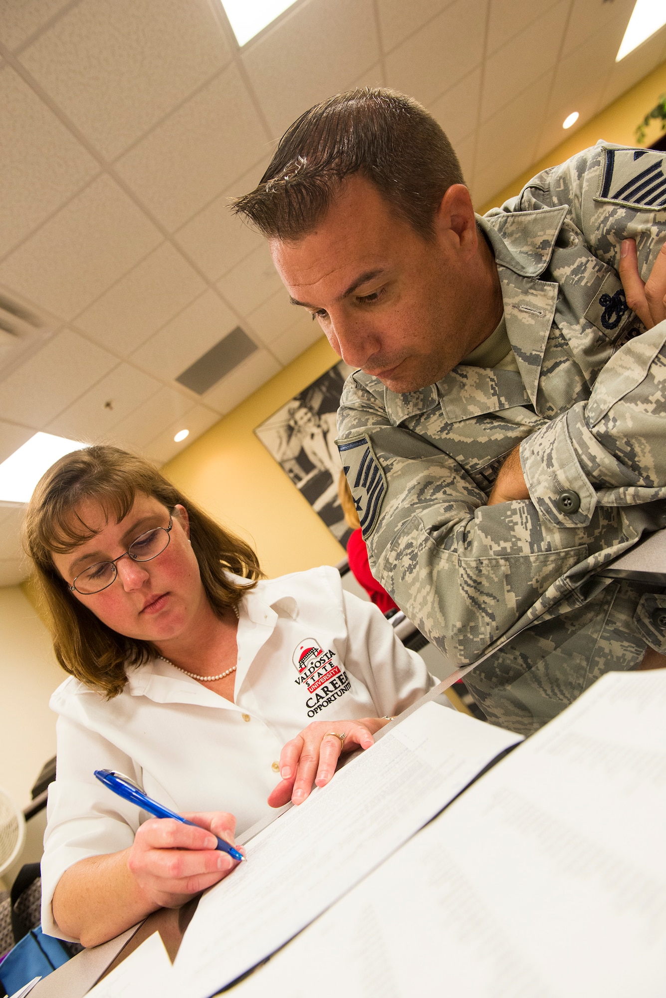 U.S. Air Force Master Sgt. John Lamp, 23d Component Maintenance Squadron first sergeant, listens to feedback from a career opportunities counselor at Moody Air Force Base, Ga., Aug. 26, 2014. The feedback highlighted common mistakes people make when résumé writing such as being lengthy and containing too many acronyms. (U.S. Air Force photo by Airman 1st Class Ceaira Tinsley/ Released)