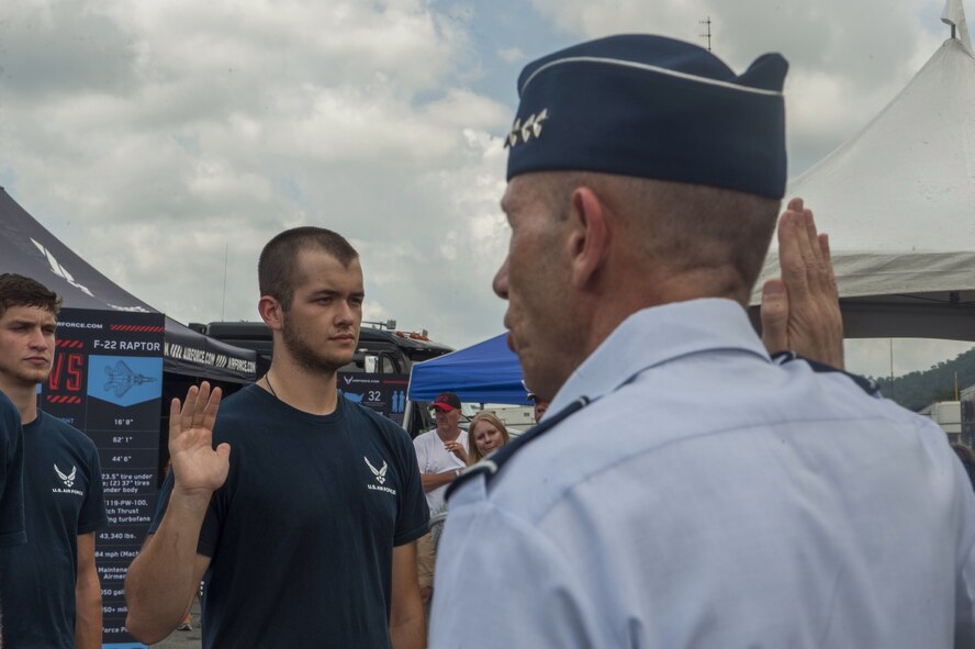 U. S. Air Force Lt. Gen. James Holmes, Headquarters U.S. Air Force Deputy Chief of Staff for Strategic Plans and Requirements, issues the oath of enlistment during a Delayed Entry Program swear-in ceremony at the Bristol Motor Speedway in Bristol, Tenn., Aug. 23, 2014. The Air Force’s NASCAR sponsorship helps allow the Air Force Recruiting Service meet its mission: to inspire, engage and recruit competitive men and women for service. (U.S. Air Force photo by Airman Dillian Bamman/Released)