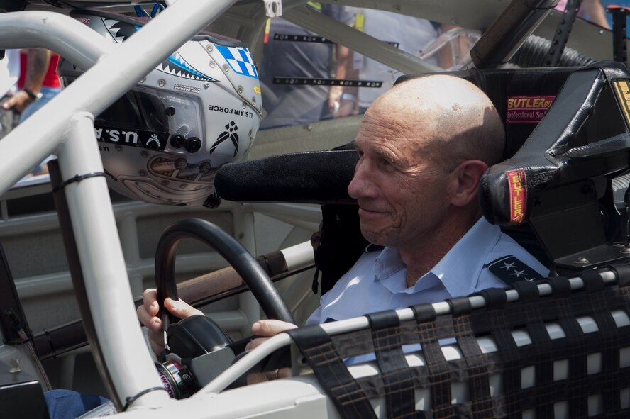 U.S. Air Force Lt. Gen. James Holmes, Headquarters U.S. Air Force Deputy Chief of Staff for Strategic Plans and Requirements, revs the engine of the NASCAR #43 show car outside of the Bristol Motor Speedway in Bristol, Tenn., August 23, 2014. The Air Force sponsors the NASCAR #43 car which is driven by Aric Almirola, son of a prior Air Force service member. (U.S. Air Force photo by Airman Dillian Bamman/Released)