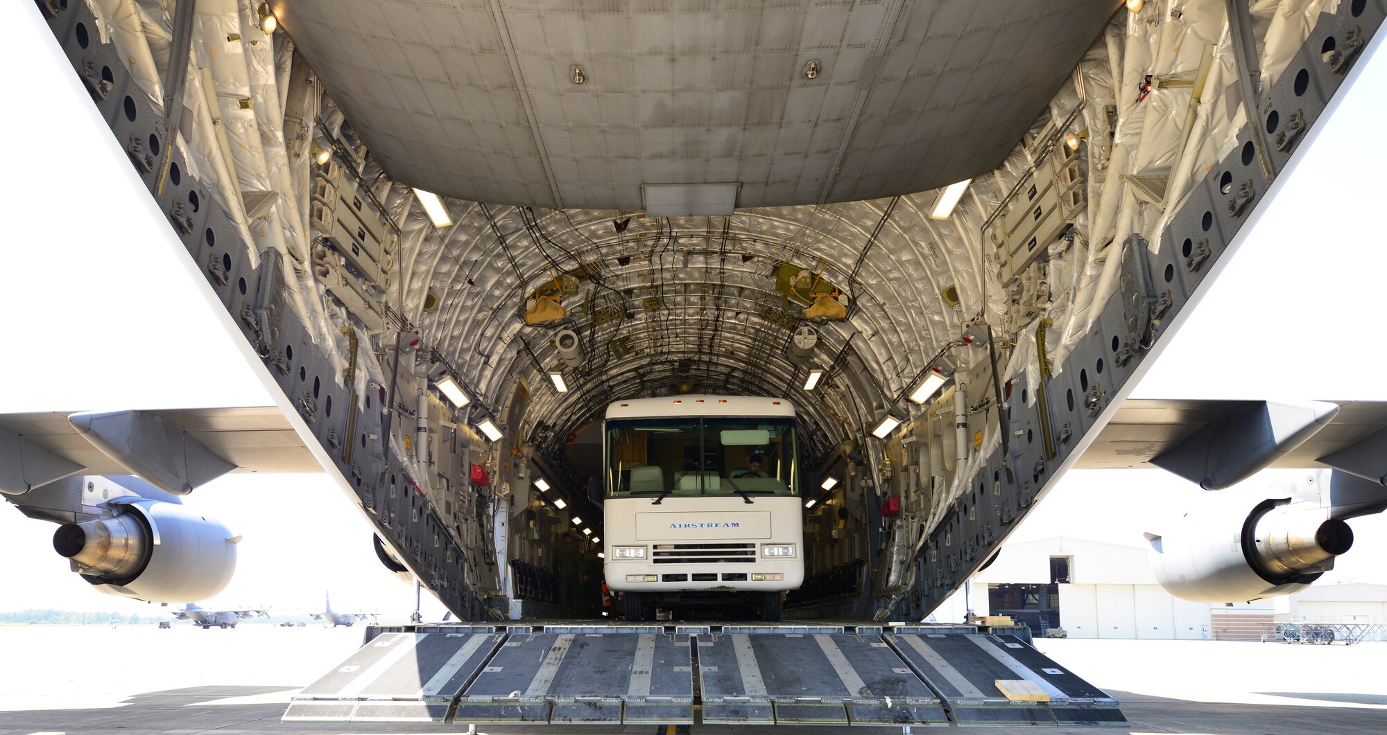 Members of the 30th Aerial Port Squadron, load a mobile dental clinic donated by the Flying Dentists Association, onto a C-17 aircraft from joint base McGuire, N.J., August 26, 2014, Niagara Falls Air Reserve Staion, N.Y. The Air Force will transport this vehicle via the Denton Cargo Program, an amendment which allows the U.S. Military to transport donated goods on a space available basis. The dental clinic is bound for the Dominican Republic where it will service approximately 30,000 people in need. (U.S. Air Force photo by Staff Sgt. Stephanie Sawyer)  
