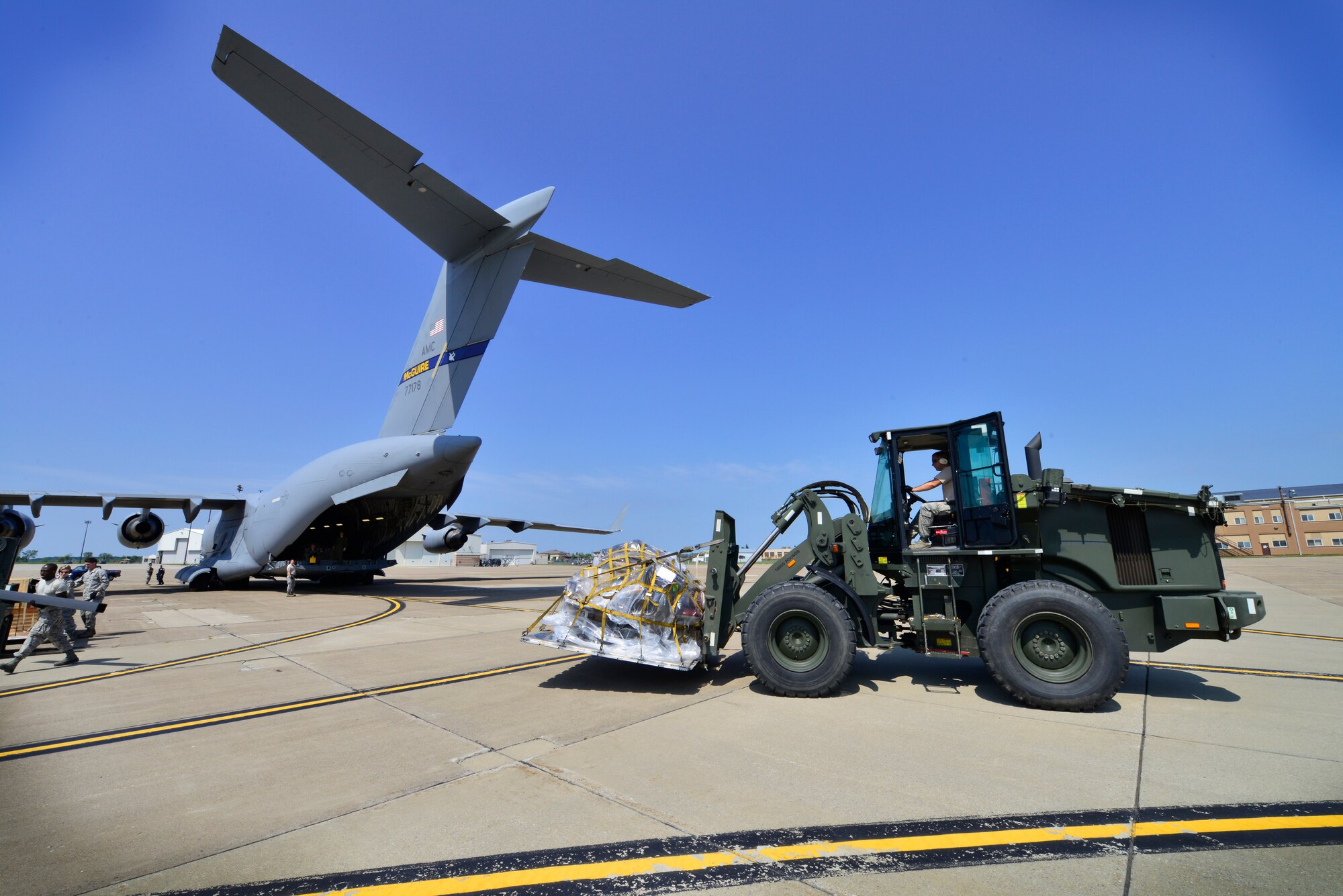 Members of the 30th Aerial Port Squadron, prepare to load a mobile dental clinic donated by the Flying Dentists Association, onto a C-17 aircraft from joint base McGuire, N.J., August 26, 2014, Niagara Falls Air Reserve Staion, N.Y. The Air Force will transport this vehicle via the Denton Cargo Program, an amendment which allows the U.S. Military to transport donated goods on a space available basis. The dental clinic is bound for the Dominican Republic where it will service approximately 30,000 people in need. (U.S. Air Force photo by Staff Sgt. Stephanie Sawyer)  