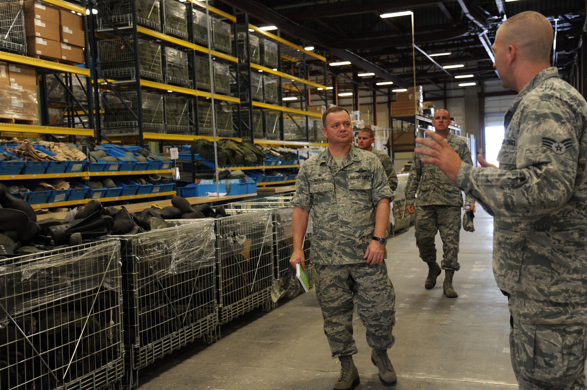 Senior Airman Cody Harper shows Col. Brian McDaniel the individual protection equipment building during the colonel’s 92nd Mission Support Group immersion at Fairchild Air Force Base, Washington, Aug. 26, 2014. McDaniel took command of the 92nd Air Refueling Wing July 25, 2014, becoming the new leader of Fairchild's host wing. As part of the immersion, he took a tour of the IPE building to greet Airmen and see what they do on a daily basis. Harper is a 92nd Logistics Readiness Squadron individual protective equipment journeyman. (U.S. Air Force photo by Airman 1st Class Janelle Patiño/Released)