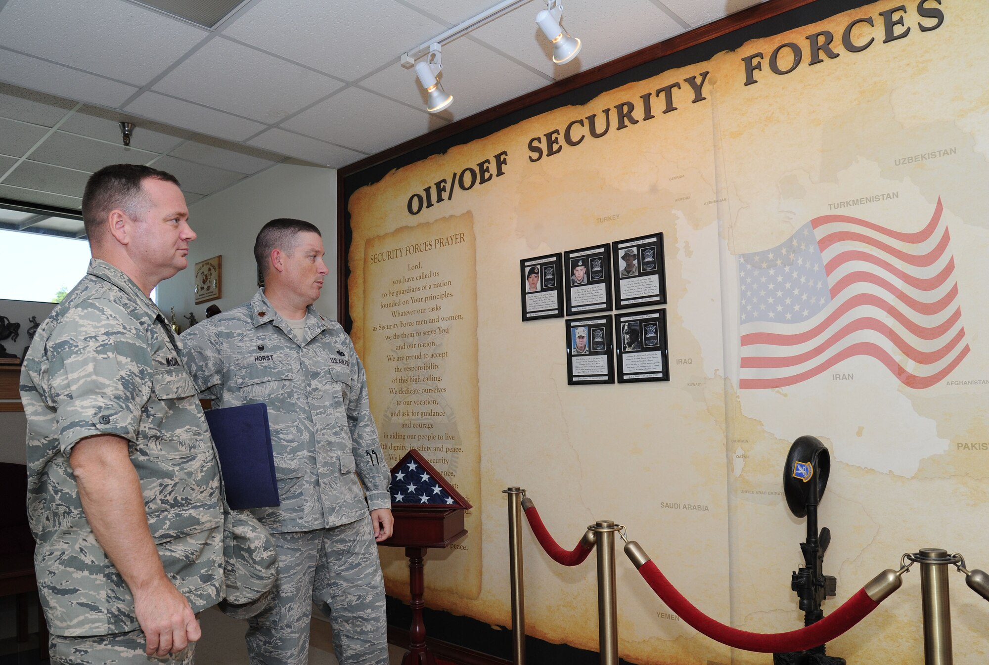 Maj. Eric Horst speaks with Col. Brian McDaniel about the wall memorial in the security forces building during the 92nd Mission Support Group immersion at Fairchild Air Force Base, Washington, Aug. 26, 2014. The wall memorial is dedicated to Airmen that have lost their lives in battle. McDaniel took command of the 92nd Air Refueling Wing on July 25, 2014 and this immersion allowed him to meet with Fairchild Airmen. Horst is the 92nd Security Forces Squadron commander. (U.S. Air Force photo by Airman 1st Class Janelle Patiño/Released)