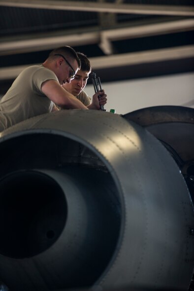 U.S. Air Force Staff Sgt. Shawn Watters, left, 476th Aircraft Maintenance Squadron environmental electrician, and Airman 1st Class Alan Maldonado, 23d Equipment Maintenance Squadron crew chief, inspect a TF34 engine on an A-10C Thunderbolt II in the A-10 phase hangar at Moody Air Force Base, Ga., Aug. 13, 2014. The phase hangar is mainly staffed by Airmen from the 23d EMS and the 23d Component Maintenance Squadron, with additional help from specialized maintenance flights. (U.S. Air Force photo by Airman 1st Class Ryan Callaghan/Released)
