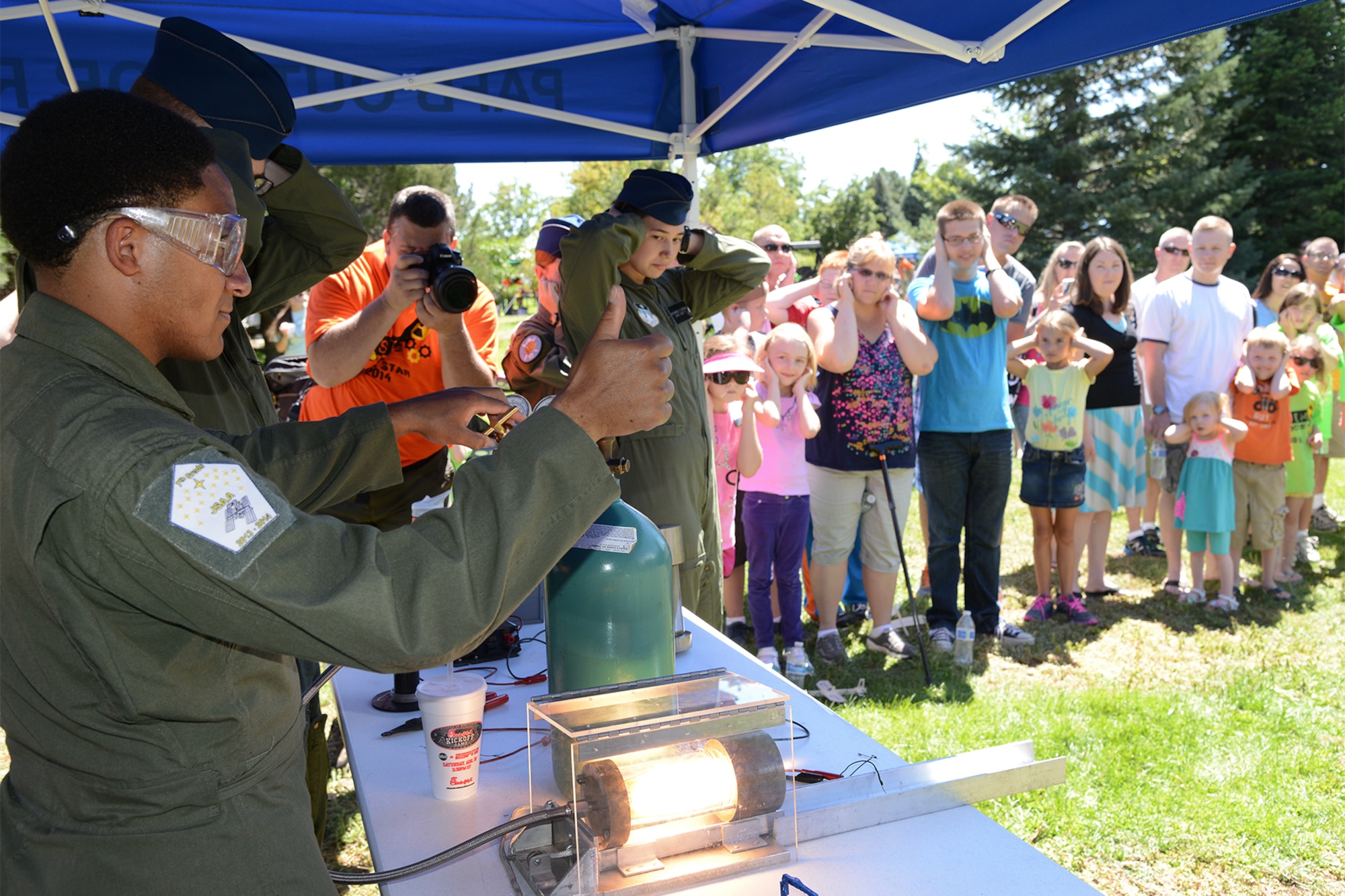 PETERSON AIR FORCE BASE, Colo. – Cadet 1st Class Winston Sanks, U.S. Air Force Academy STEM outreach club, gives the thumbs up as he powers a rocket thruster. Cadets from the Academy conduct 20-25 STEM events each semester. Children and parents could visit nearly 30 booths to learn about Science, Technology, Engineering and Math in a fun, carnival-like environment Aug 23 at STEM Rocks!. (U.S. Air Force photo/ Tech. Sgt. Jared Marquis)