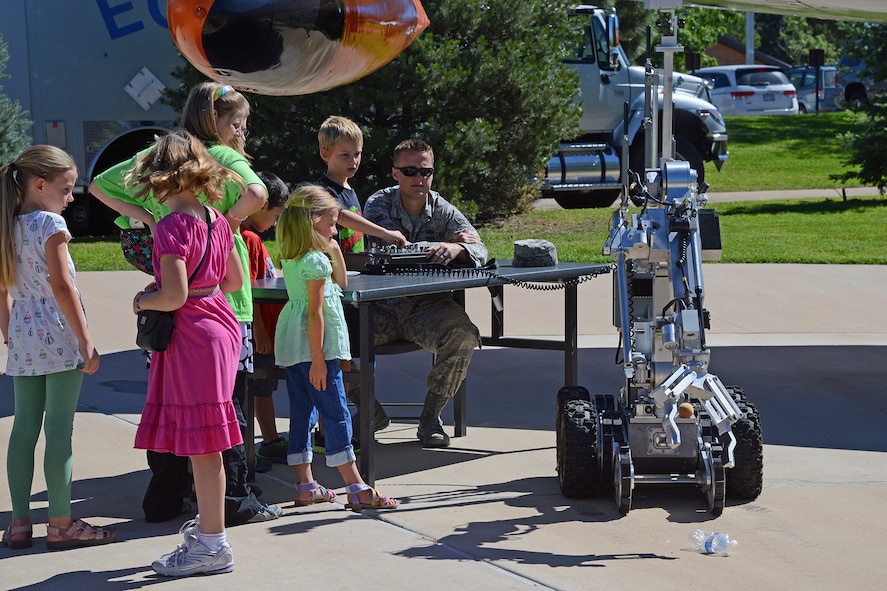 PETERSON AIR FORCE BASE, Colo. – Children who attended STEM Rocks! at the Peterson Air and Space Museum Aug. 23 had the opportunity to learn to drive the 21st Civil Engineer Squadron Explosive Ordnance Disposal robot. At one point the U.S. Air Force Academy PACBOT 4, a smaller version, challenged the EOD robot, but was easily thwarted. Children and parents could visit nearly 30 booths to learn about Science, Technology, Engineering and Math in a fun, carnival-like environment. (U.S. Air Force photo/Tech. Sgt. Jared Marquis)