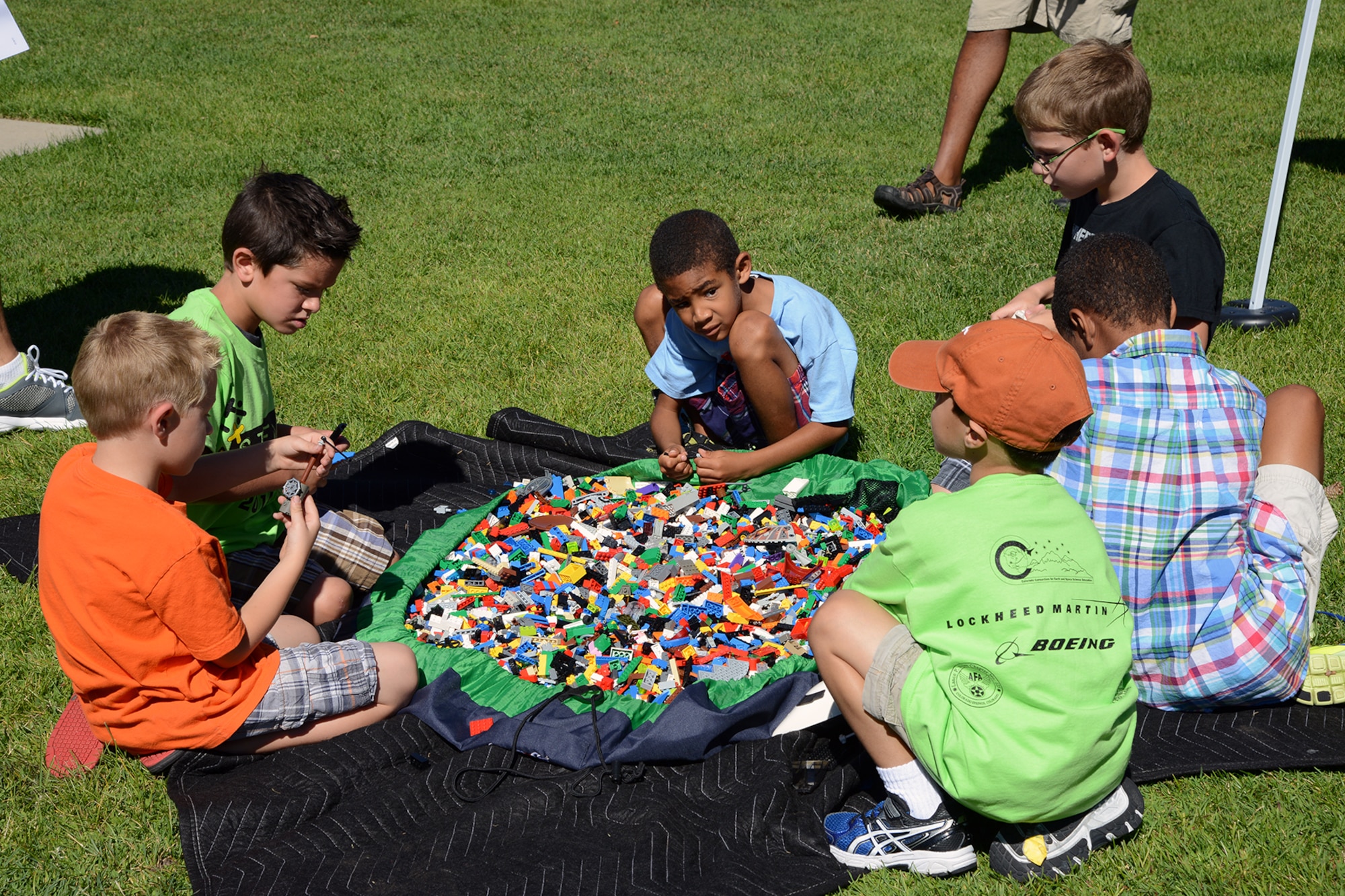 PETERSON AIR FORCE BASE, Colo. – Several children play with Legos during the STEM Rocks! event Aug. 23 at the Peterson Air and Space Museum. Children and parents could visit nearly 30 booths to learn about Science, Technology, Engineering and Math in a fun, carnival-like environment. (U.S. Air Force photo/Tech. Sgt. Jared Marquis)