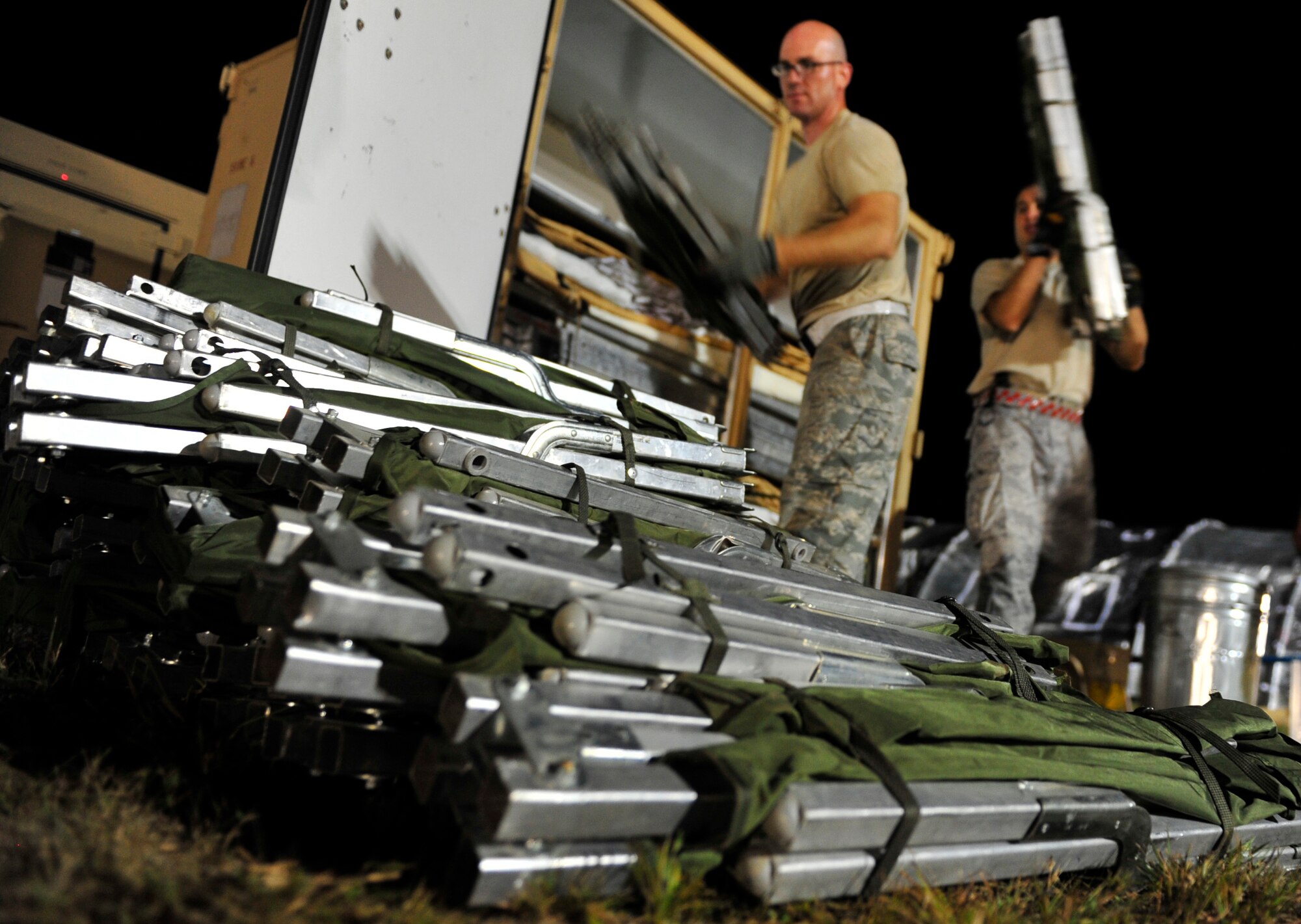 JOINT BASE MCGUIRE-DIX-LAKEHURST, N.J. - Airmen from the 817th Contingency Response Wing unpack cots on day one of Eagle Flag 14-3, here, at the Lakehurst Naval Air Station, Aug. 11, 2014. The two-week long exercise that tested their ability to work along-side each other as a Joint Task Force-Port Opening (JTF-PO) team. The JTF-PO specializes in establishing hubs for cargo distribution operations worldwide, to include remote or damaged locations, on short notice. (U.S. Air Force photo by Staff Sgt. Gustavo Gonzalez)