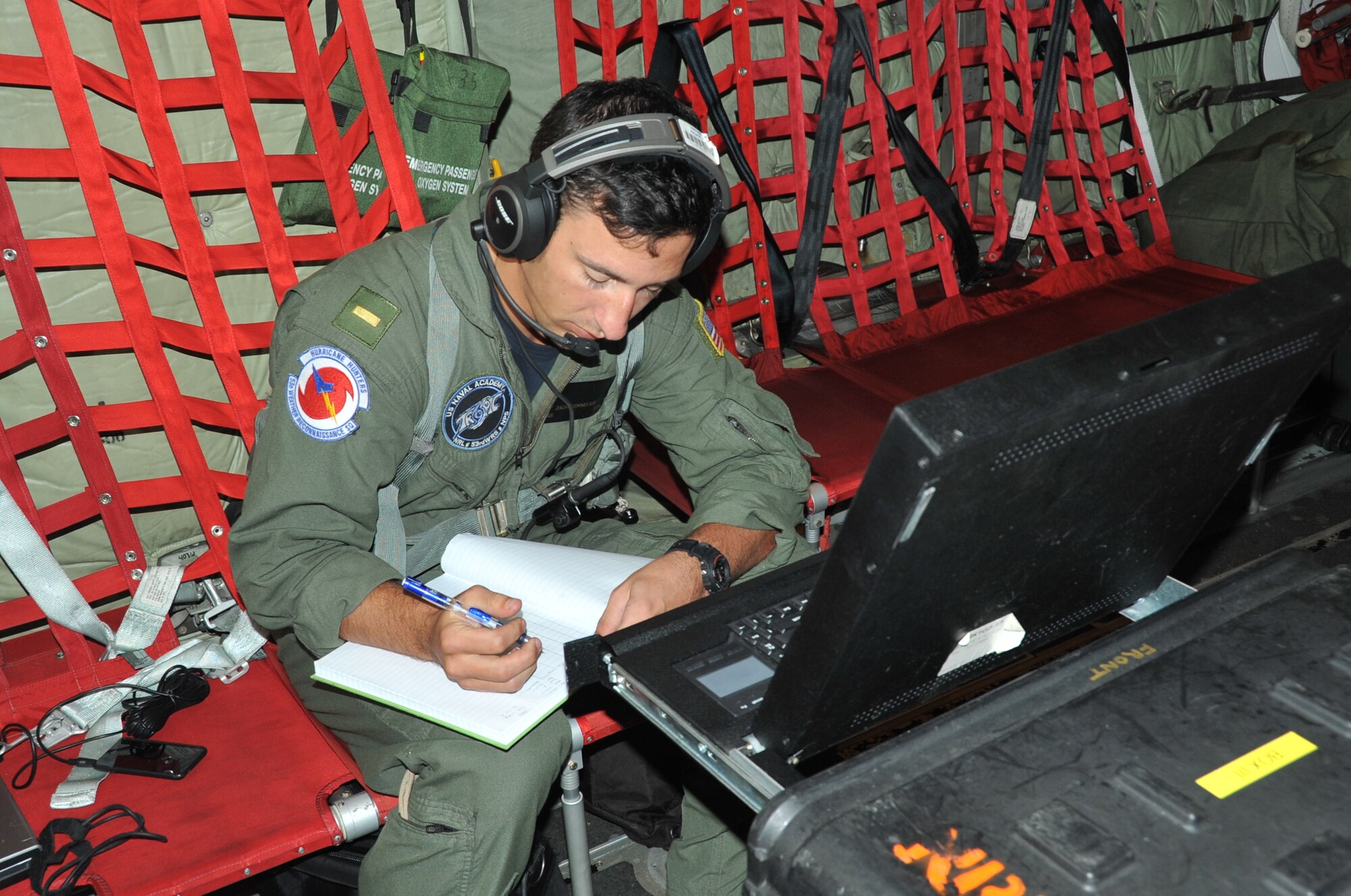 U.S. Navy Ensign Zach Cornelius, U.S. Naval Academy Training and Research in Oceanic and Atmospheric Processes in Tropical Cyclones internship program, collects data from an Airborne/Air Expendable Bathythermograph, or AXBT, deepwater bouy. The 53rd Weather Reconnaissance Squadron dropped several bouys during a 96L, now Hurricane Cristobal, invest mission over the Caribbean Aug. 23, 2014. The bouys were launched out of a tube in the back of the WC-130J. The bouys radio back information about ocean surface temperatures. The 53rd WRS and TROPIC research team have worked together for four years on this research project designed to assist the National Hurricane Center increase the accurace of hurricane forecasts by incorporating ocean data. (U.S. Air Force photo/Maj. Marnee A.C. Losurdo)