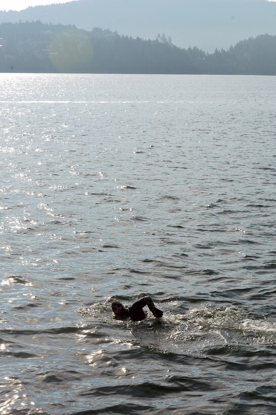 Airman 1st Class David Knutson, 627th Force Support Squadron evaluations technician, swims alone to help raise awareness for victims of post-traumatic stress Aug. 25, 2014, during the Swim to Live event in the Bellingham Bay, Wash. Joined by members of the U.S. Army, U.S. Coast Guard and Canadian Armed Forces, McChord Airmen jumped into the Bellingham Bay just and took turns swimming as long as their bodies would allow before tagging out with another swimmer. (U.S. Air Force photo/Staff Sgt. Russ Jackson)