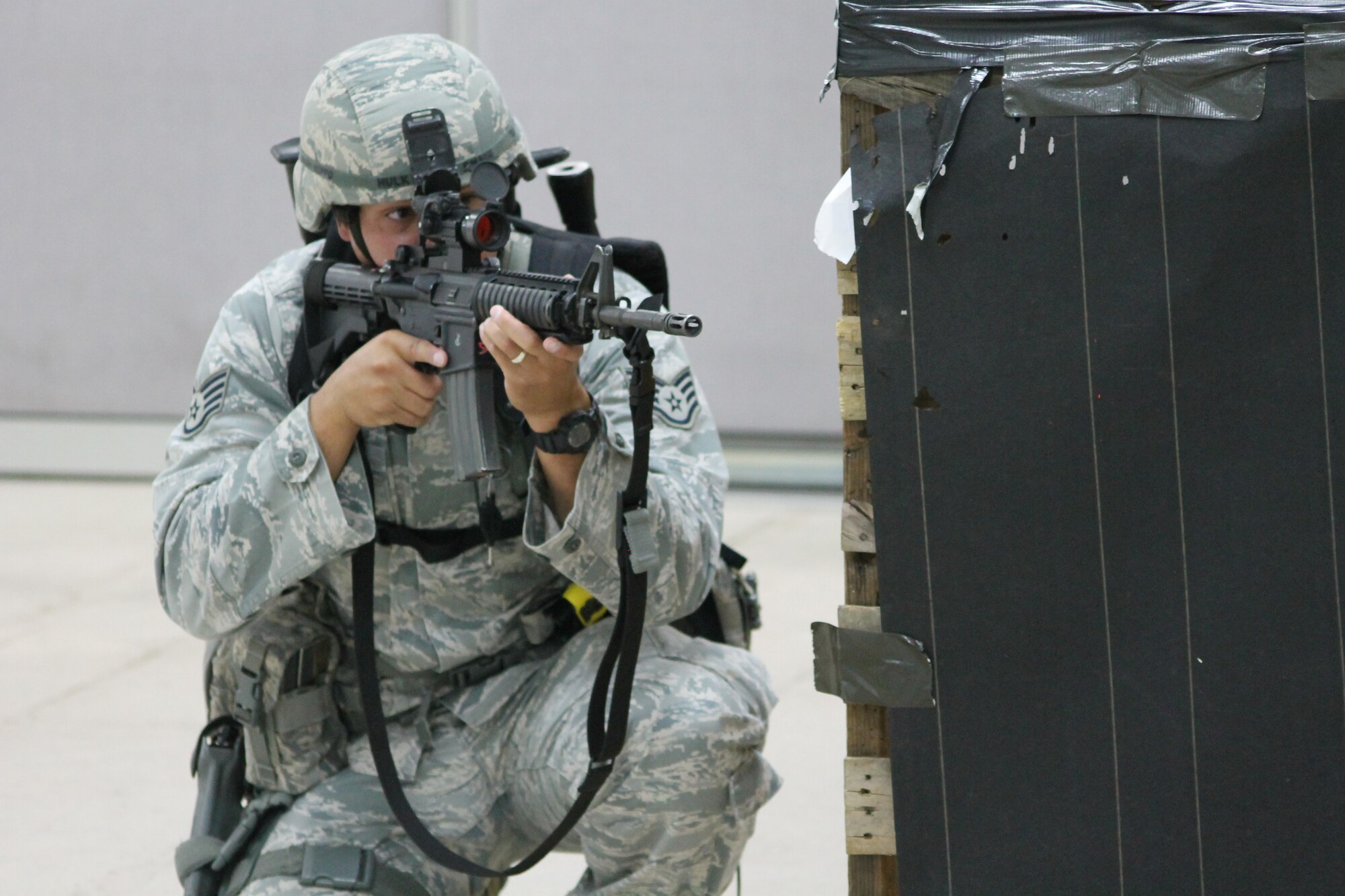 PETERSON AIR FORCE BASE, Colo. — A 21st Security Forces Squadron Airman provides security while a fellow Airman is treated for a gunshot wound to the leg, all part of a simulated active shooter and hostage scenario during this month’s Condor Crest exercise. The quarterly exercise is designed to test and evaluate base readiness for real-word events. (U.S. Air Force photo/Michael Golembesky)