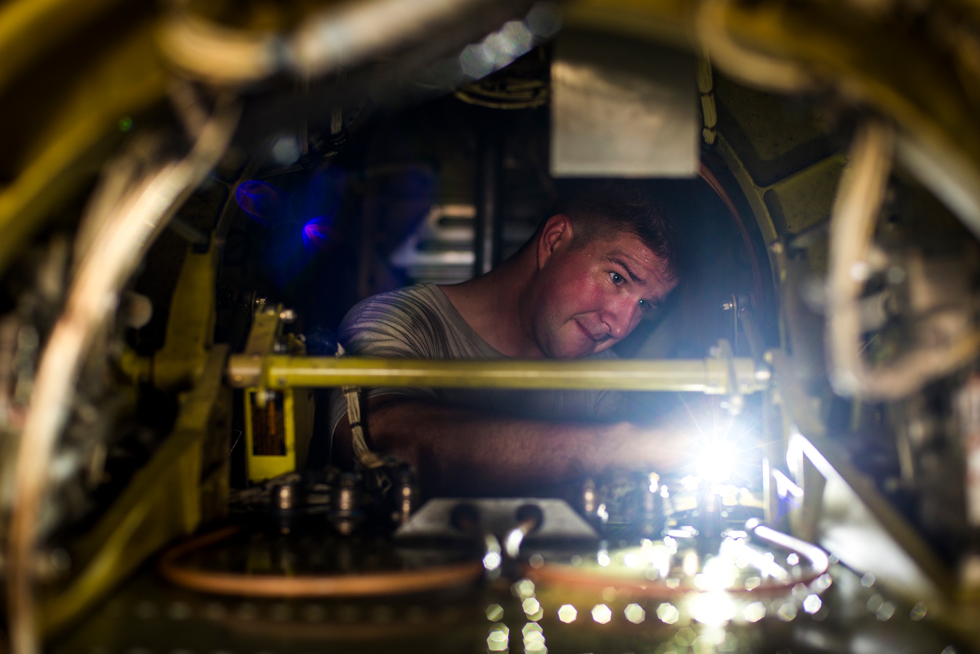 U.S. Air Force Staff Sgt. Matthew Ragsdale, 23d Equipment Maintenance Squadron crew chief, inspects the right elevator-actuator in an A-10C Thunderbolt II at Moody Air Force Base, Ga., Aug. 12, 2014. Ragsdale was inspecting the actuator as part of a phase two inspection in the A-10 phase hanger. (U.S. Air Force photo by Airman 1st Class Ryan Callaghan/Released)