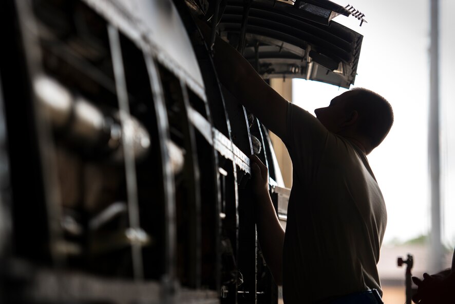 U.S. Air Force Staff Sgt. Collin Crowe, 23d Aircraft Maintenance Squadron avionics technician, installs upgrades onto an A-10C Thunderbolt II in the A-10 phase hanger at Moody Air Force Base, Ga., July 30, 2014. Crowe was installing an Ethernet cable to allow faster communication between the components on the aircraft. (U.S. Air Force photo by Airman 1st Class Ryan Callaghan/Released)