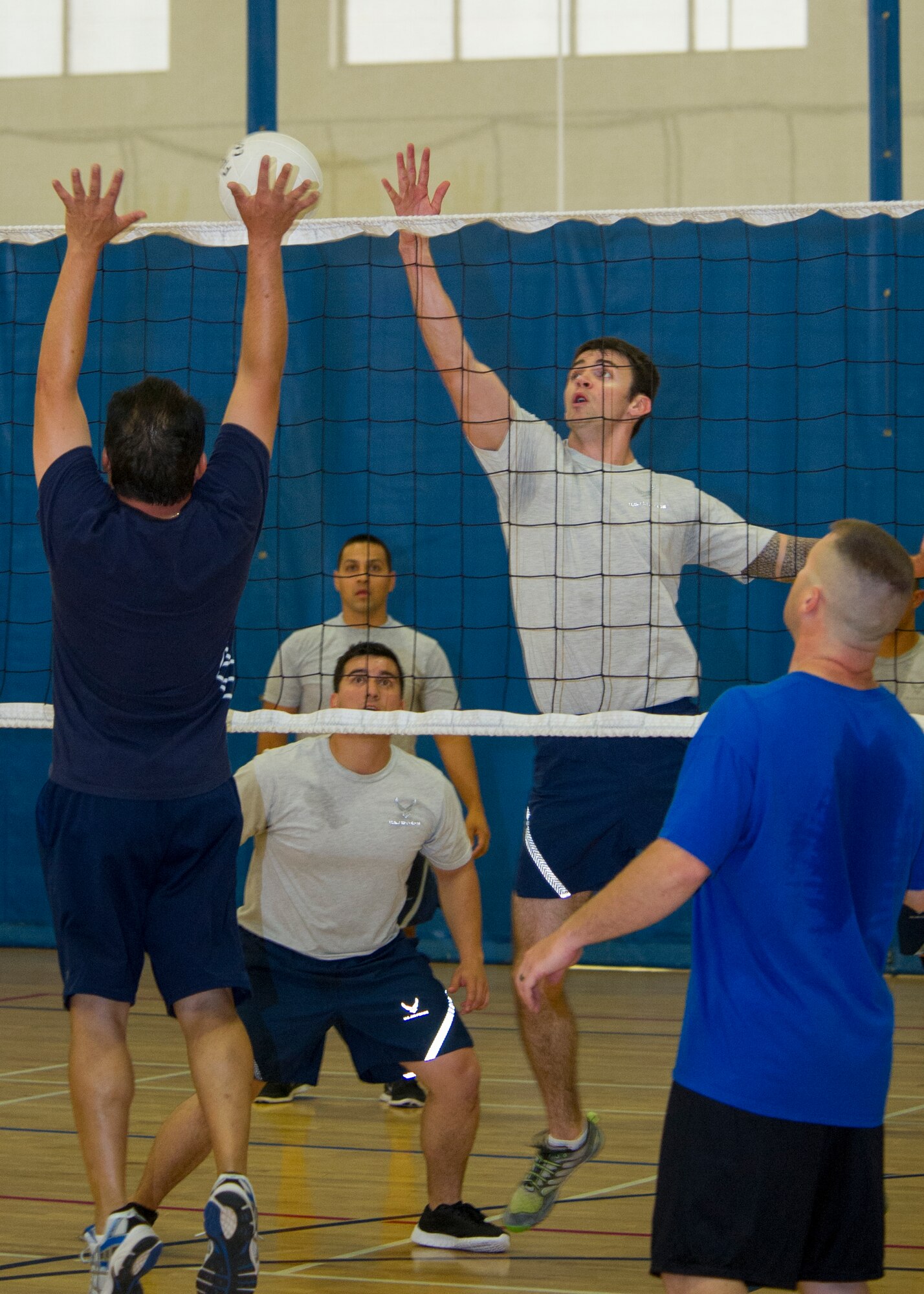 Members of Team Holloman participate in a game of volleyball at Holloman Air Force Base, N.M., Aug. 26. The Domenici Fitness Center offers several intramural sports and fitness programs to help Airmen and their families reach their health and fitness goals. In 2004, the Air Force launched a revamped physical fitness assessment standard that was more closely aligned with the readiness requirements of the post 9/11 deployed environment. Since its introduction, the program has changed the way that it measures the individual components, but the goal of ensuring that America’s Air Force is fit-to-fight has never changed. (U.S. Air Force photo by Airman 1st Class Aaron Montoya / Released)