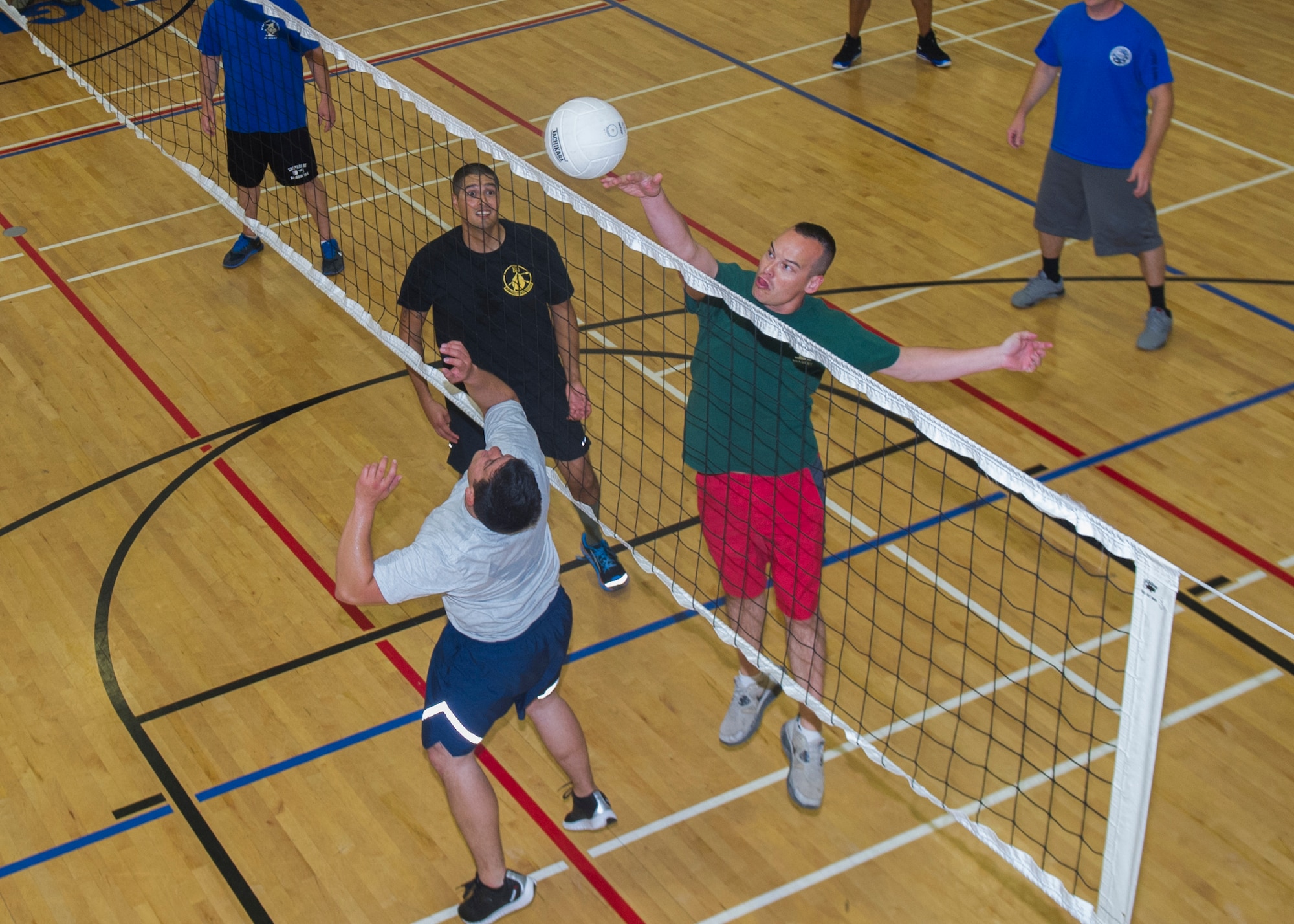 Members of Team Holloman participate in a game of volleyball at Holloman Air Force Base, N.M., Aug. 26. The Domenici Fitness Center offers several intramural sports and fitness programs to help Airmen and their families reach their health and fitness goals. In 2004, the Air Force launched a revamped physical fitness assessment standard that was more closely aligned with the readiness requirements of the post 9/11 deployed environment. Since its introduction, the program has changed the way that it measures the individual components, but the goal of ensuring that America’s Air Force is fit-to-fight has never changed. (U.S. Air Force photo by Airman 1st Class Aaron Montoya / Released)