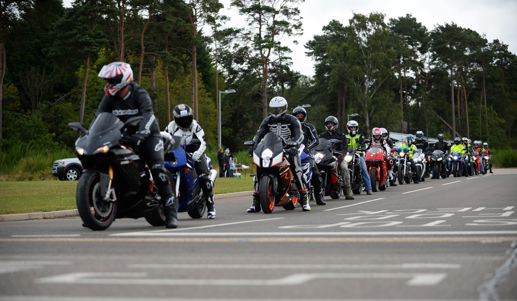 Motorcyclists prepare to go through a closed course during a motorcycle cornering event on the flightline at Royal Air Force Lakenheath, Aug. 22, 2014. The cornering event was held to sharpen rider’s motorcycling skills and to help riders become more familiar with their motorcycle’s capabilities. Riders were coached by various motorcycle club members from the local area. (U.S. Air Force Photo by Staff Sgt. Emerson Nuñez/Released)