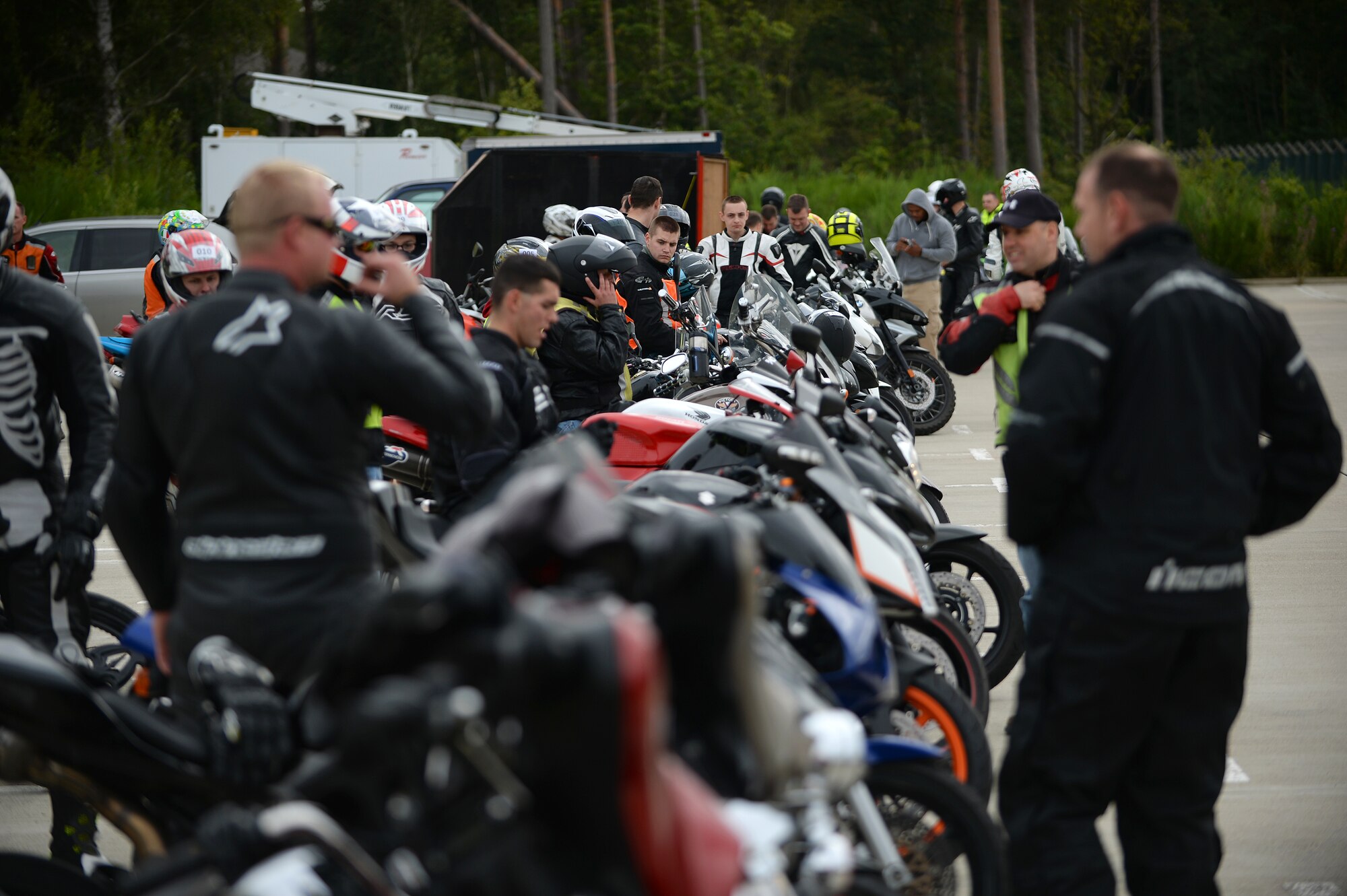Motorcyclists share riding tips with each other during a motorcycle cornering event on the flightline at Royal Air Force Lakenheath, Aug. 22, 2014. The cornering event was held on a closed course with riding coaches standing by to give rider’s tips on cornering and other manoeuvres. Coaches came from various clubs in the local area. (U.S. Air Force Photo by Staff Sgt. Emerson Nuñez/Released)