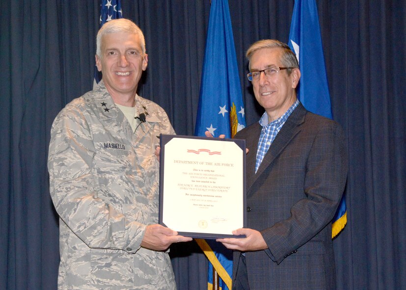 Maj. Gen. Tom Masiello, Air Force Research Laboratory commander, presents Dr. David Hardy, director of the AFRL Directed Energy Directorate, with the Air Force Organizational Excellence Award Aug. 18 at Kirtland Air Force Base, N.M. This is the fifth AFOEA the directorate has received since 1997. (Photo by Dennis Carlson) 