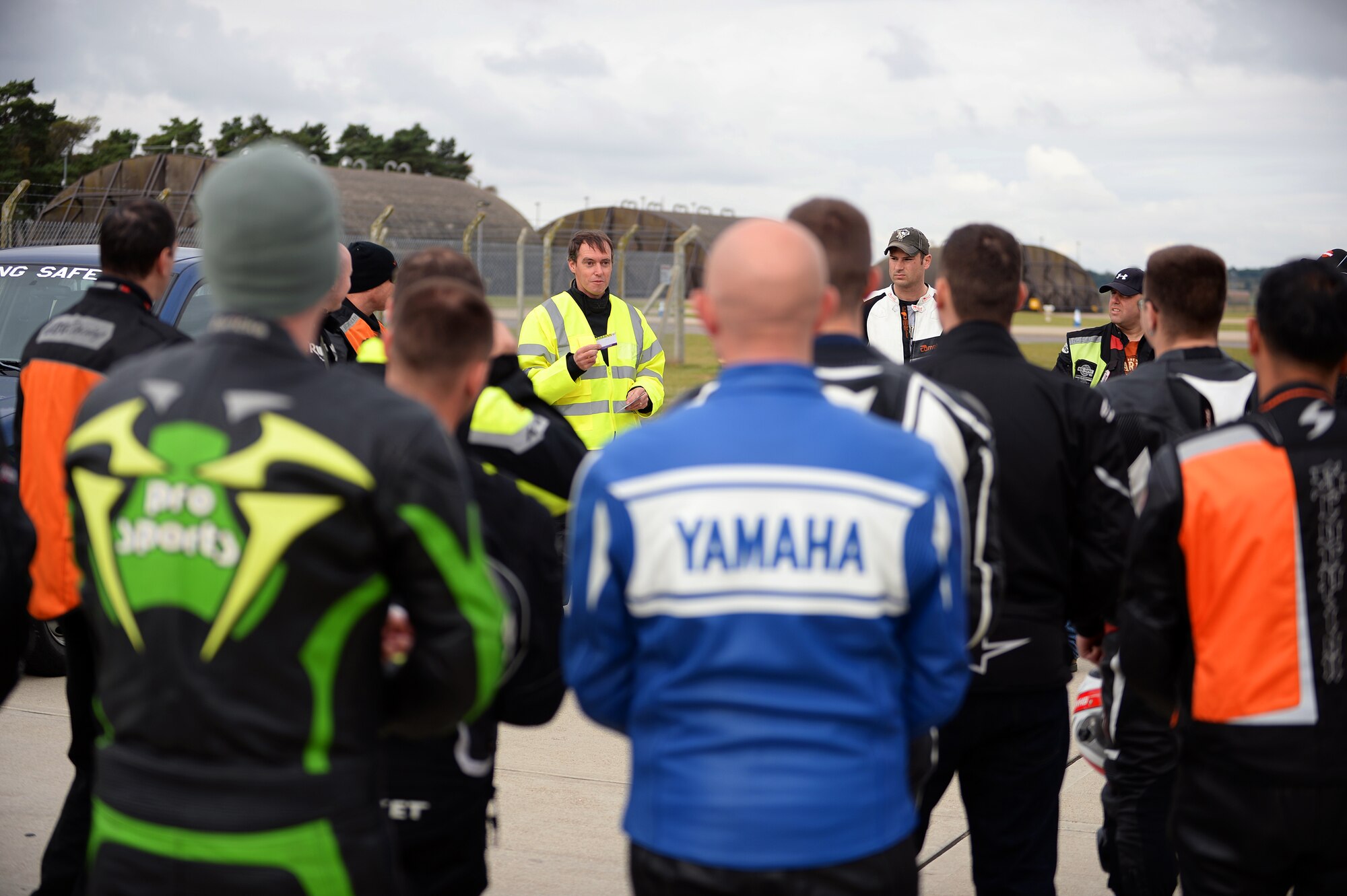 Ian Burrell, MBE, Chairman of the Ambulance Motorcycle Club U.K., encourages riders to have crash cards in their helmets during a motorcycle cornering event on the flightline at Royal Air Force Lakenheath, Aug. 22, 2014. The crash card is placed inside a rider's helmet to identify the unconscious rider in the event of an accident. (U.S. Air Force Photo by Staff Sgt. Emerson Nuñez/Released)